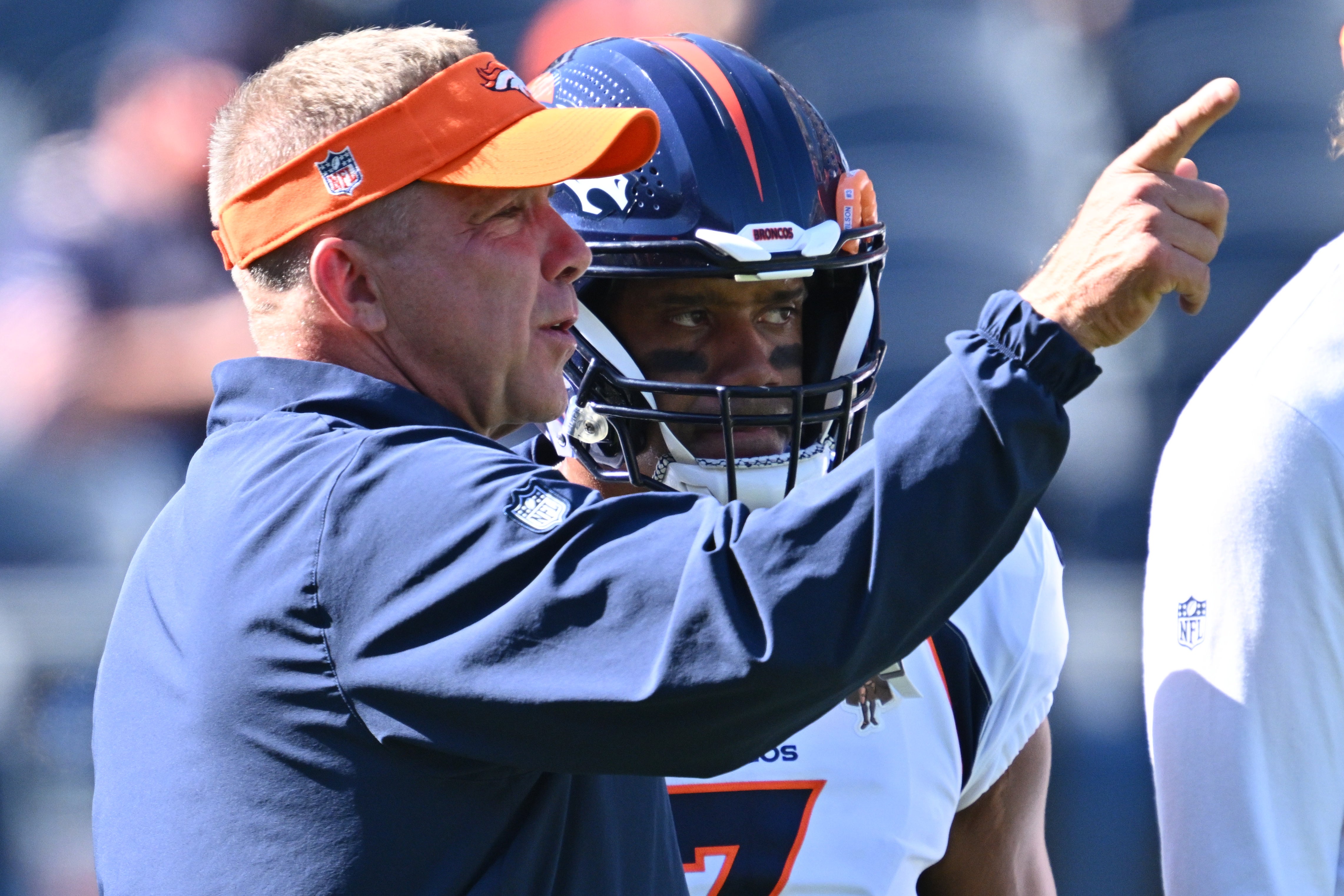 Denver Broncos head coach Sean Payton talking to Russell Wilson during their game against the Chicago Bears