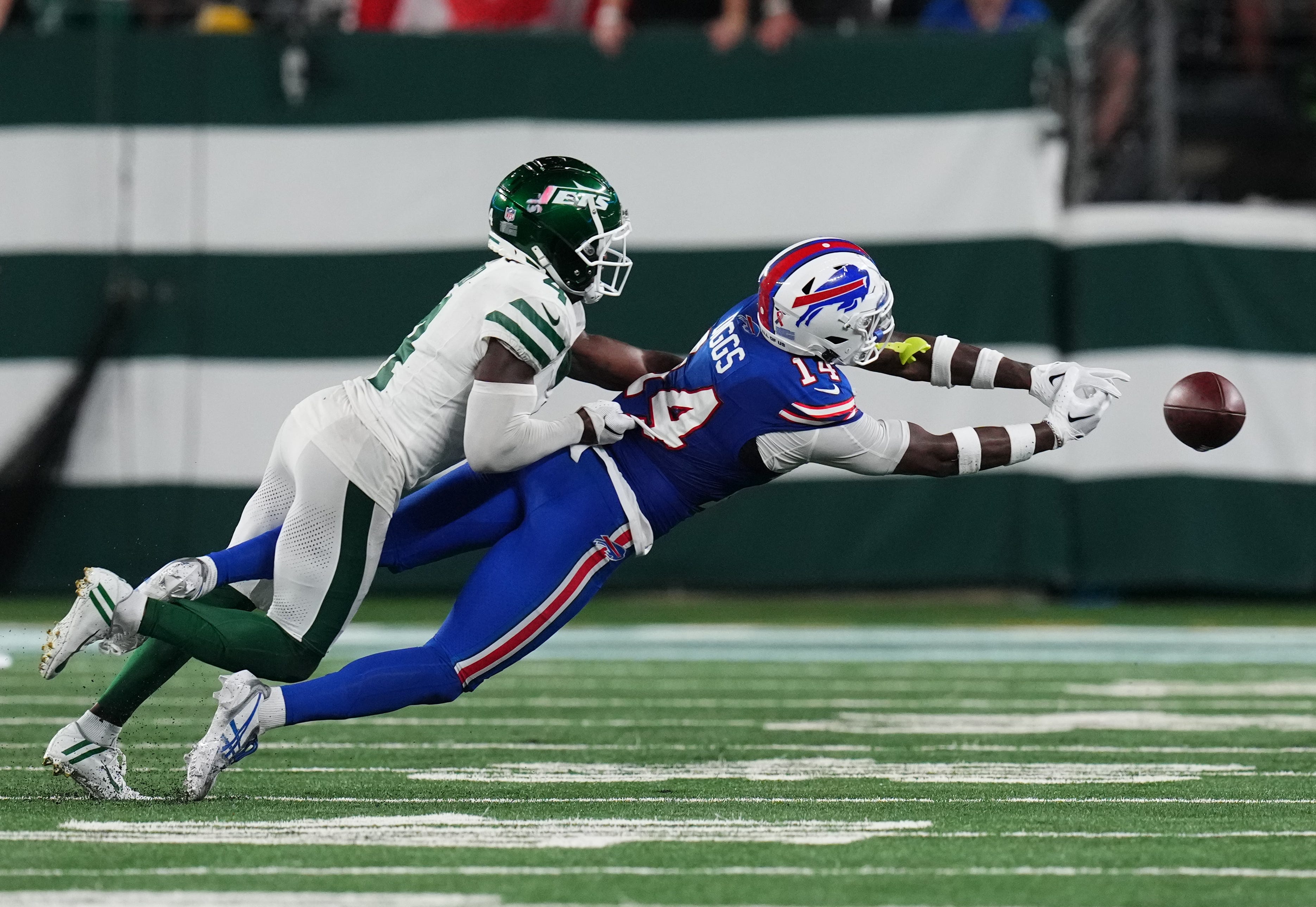 Buffalo Bills wide receiver Stefon Diggs (14) cannot complete the pass with pressure from New York Jets cornerback D.J. Reed (4) in the second half. The Jets defeat the Bills in overtime, 22-16, in the home opener at MetLife Stadium on Monday, Sept. 11, 2023, in East Rutherford.  Danielle Parhizkaran/NorthJersey.com / USA TODAY NETWORK