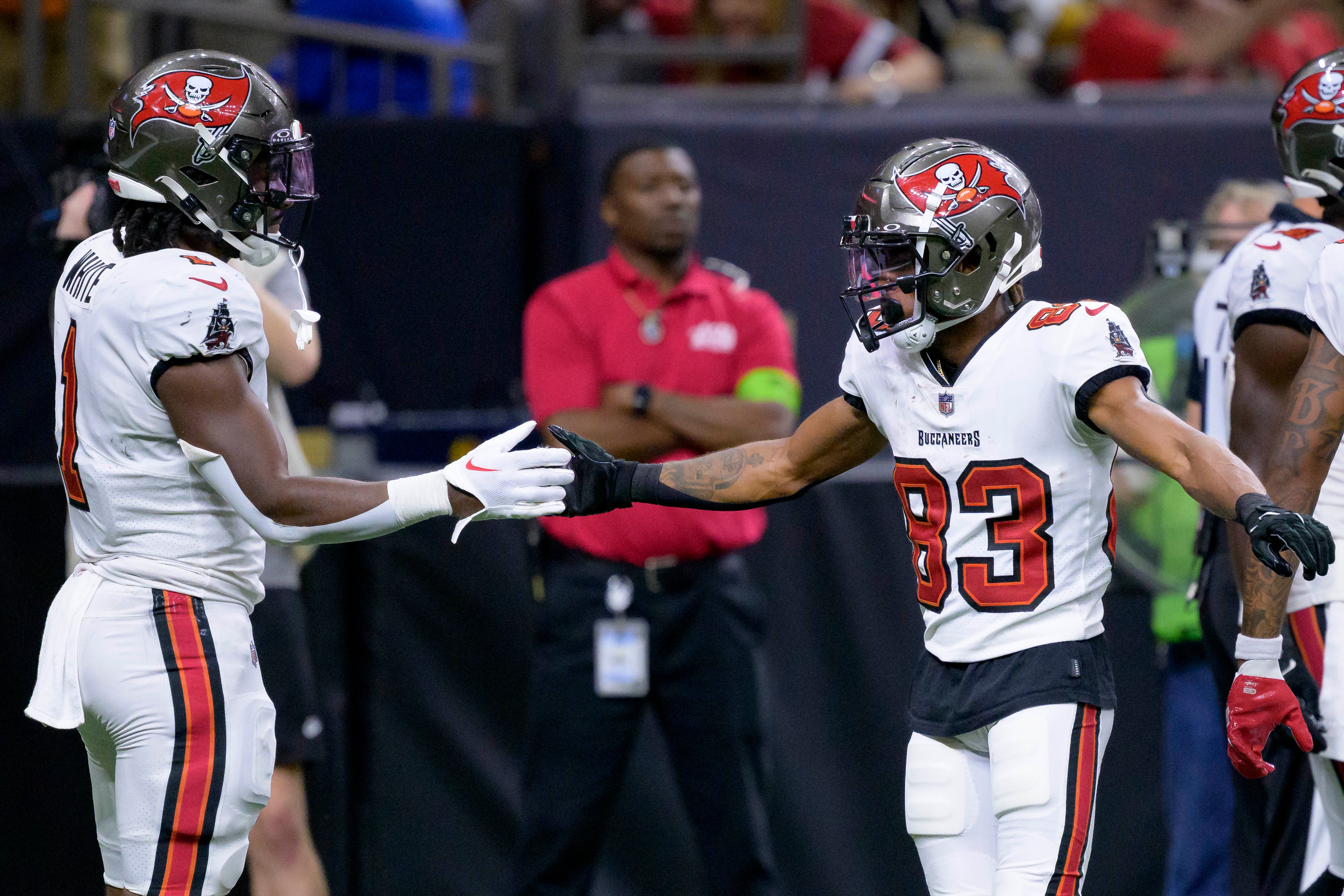 Oct 1, 2023; New Orleans, Louisiana, USA; Tampa Bay Buccaneers wide receiver Deven Thompkins (83) celebrates a touchdown with running back Rachaad White (1) against the New Orleans Saints during the fourth quarter at the Caesars Superdome. Mandatory Credit: Matthew Hinton-USA TODAY Sports