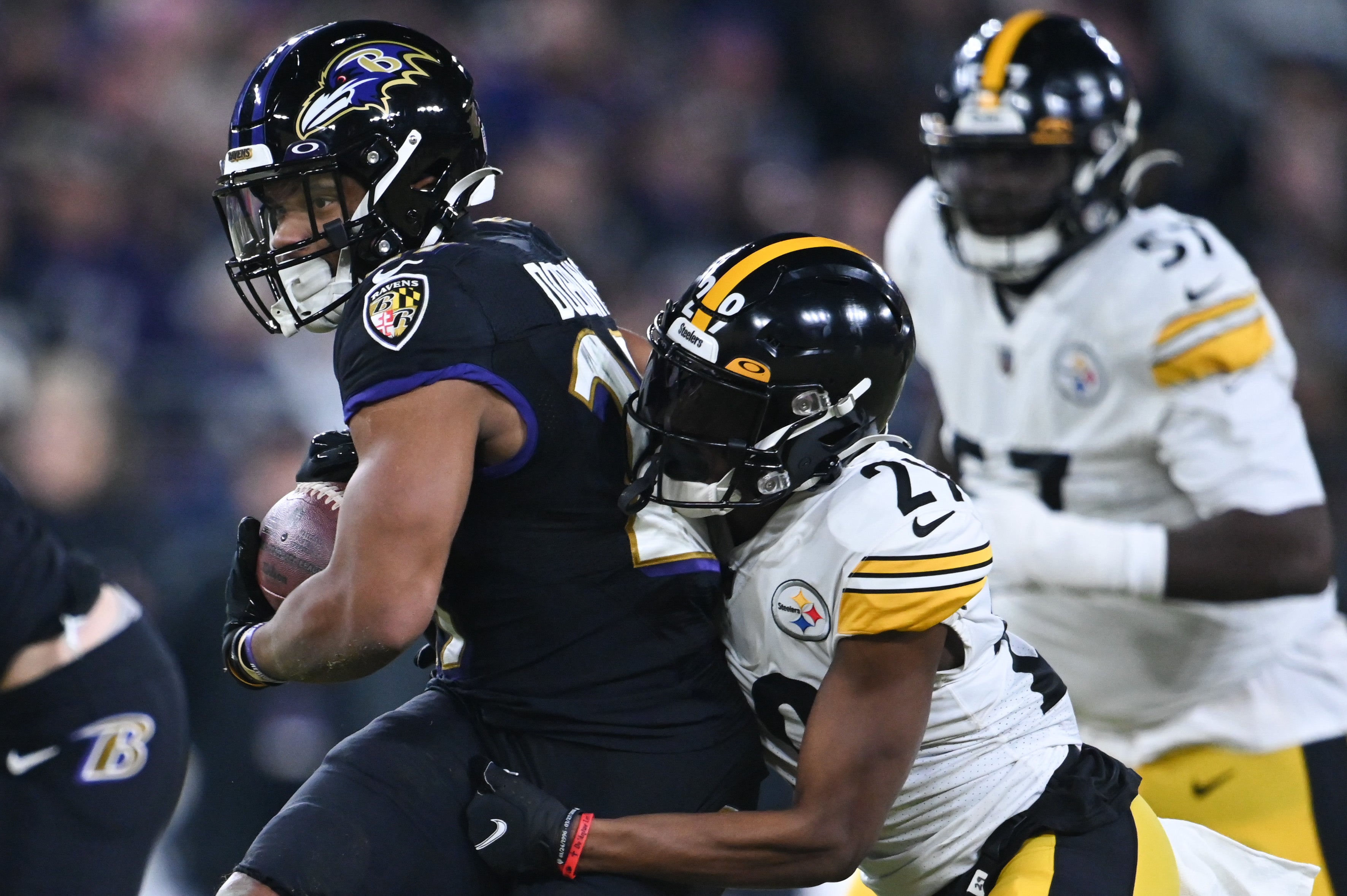 Jan 1, 2023; Baltimore, Maryland, USA; Baltimore Ravens running back J.K. Dobbins (27) rushes as Pittsburgh Steelers cornerback Levi Wallace (29) attempts to tackle during the first half at M&T Bank Stadium. Mandatory Credit: Tommy Gilligan-USA TODAY Sports  