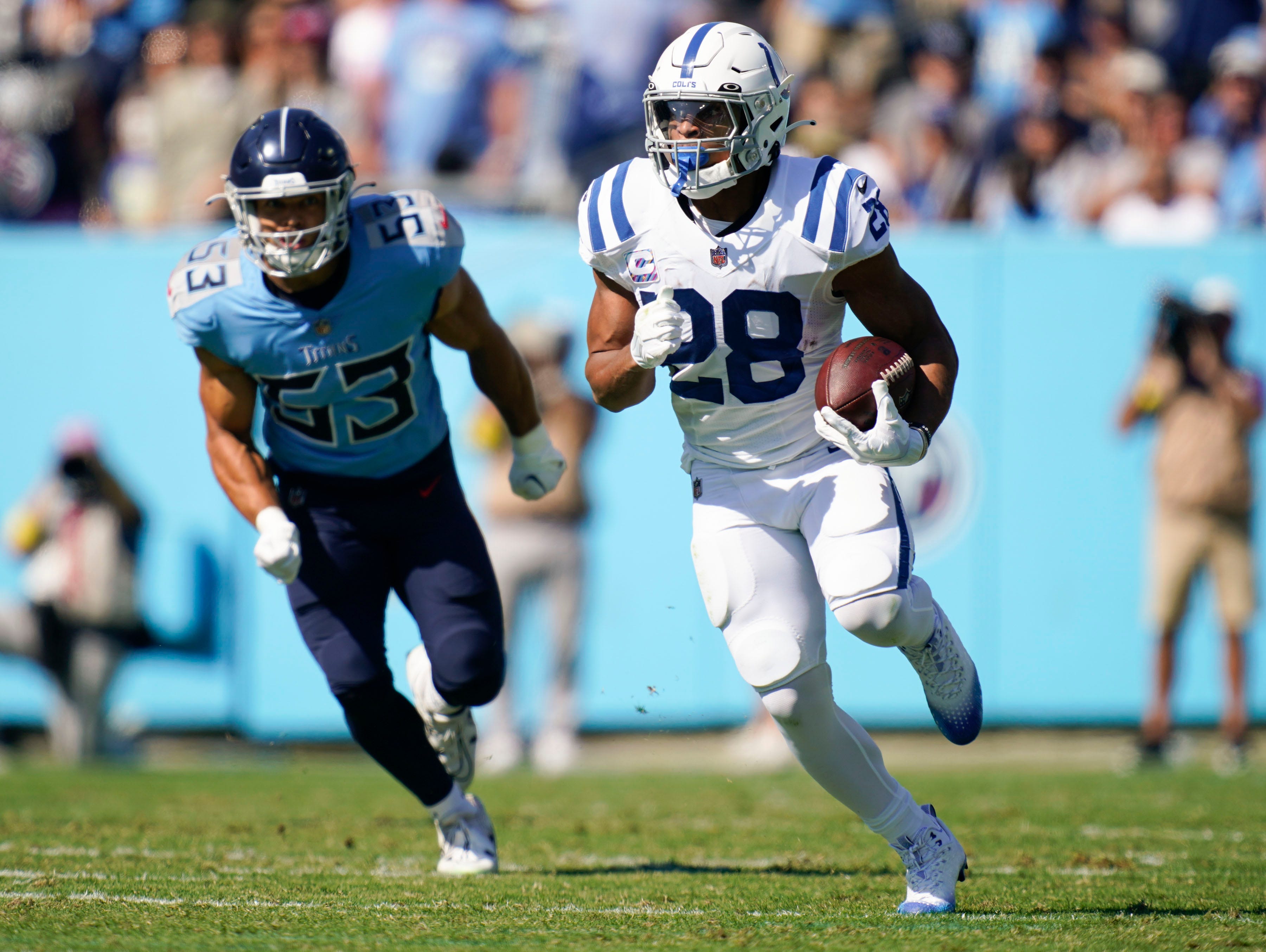 Indianapolis Colts running back Jonathan Taylor (28) runs the ball past Tennessee Titans linebacker Dylan Cole (53) during the first quarter at Nissan Stadium Sunday, Oct. 23, 2022, in Nashville, Tenn. Nfl Indianapolis Colts At Tennessee Titans