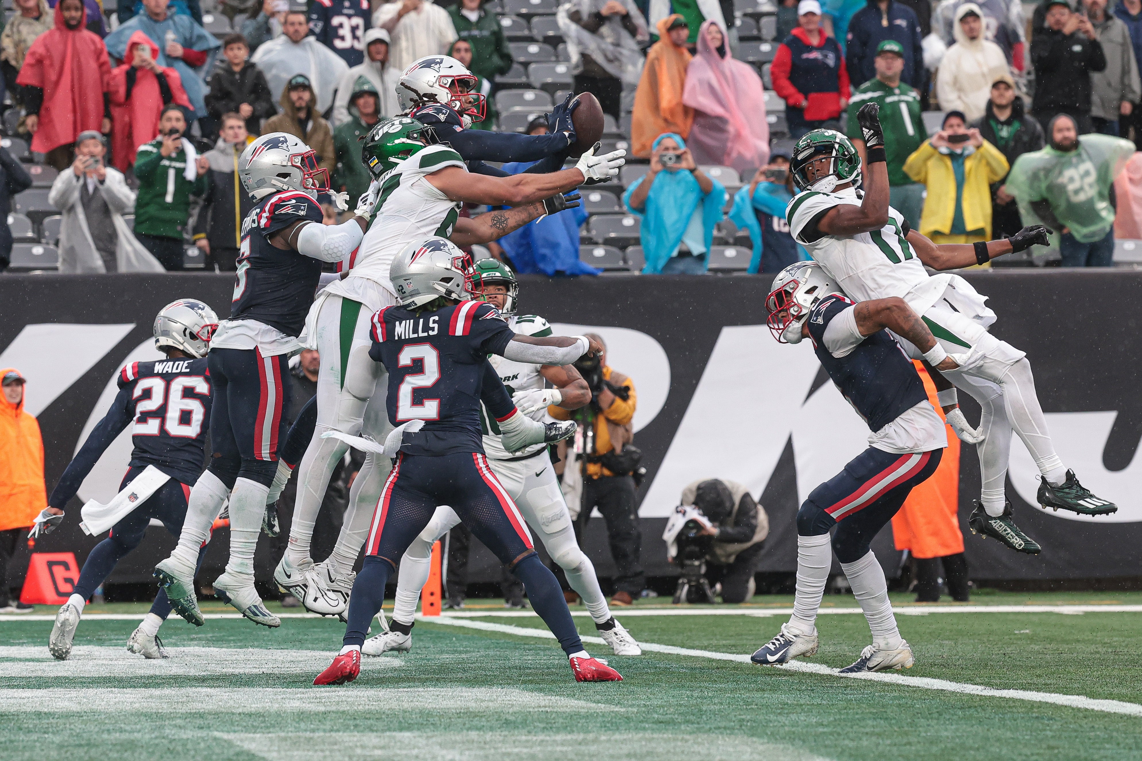 Sep 24, 2023; East Rutherford, New Jersey, USA; New England Patriots wide receiver Demario Douglas (81) bats away a pass in front of New York Jets tight end C.J. Uzomah (87) as time expires at MetLife Stadium.
