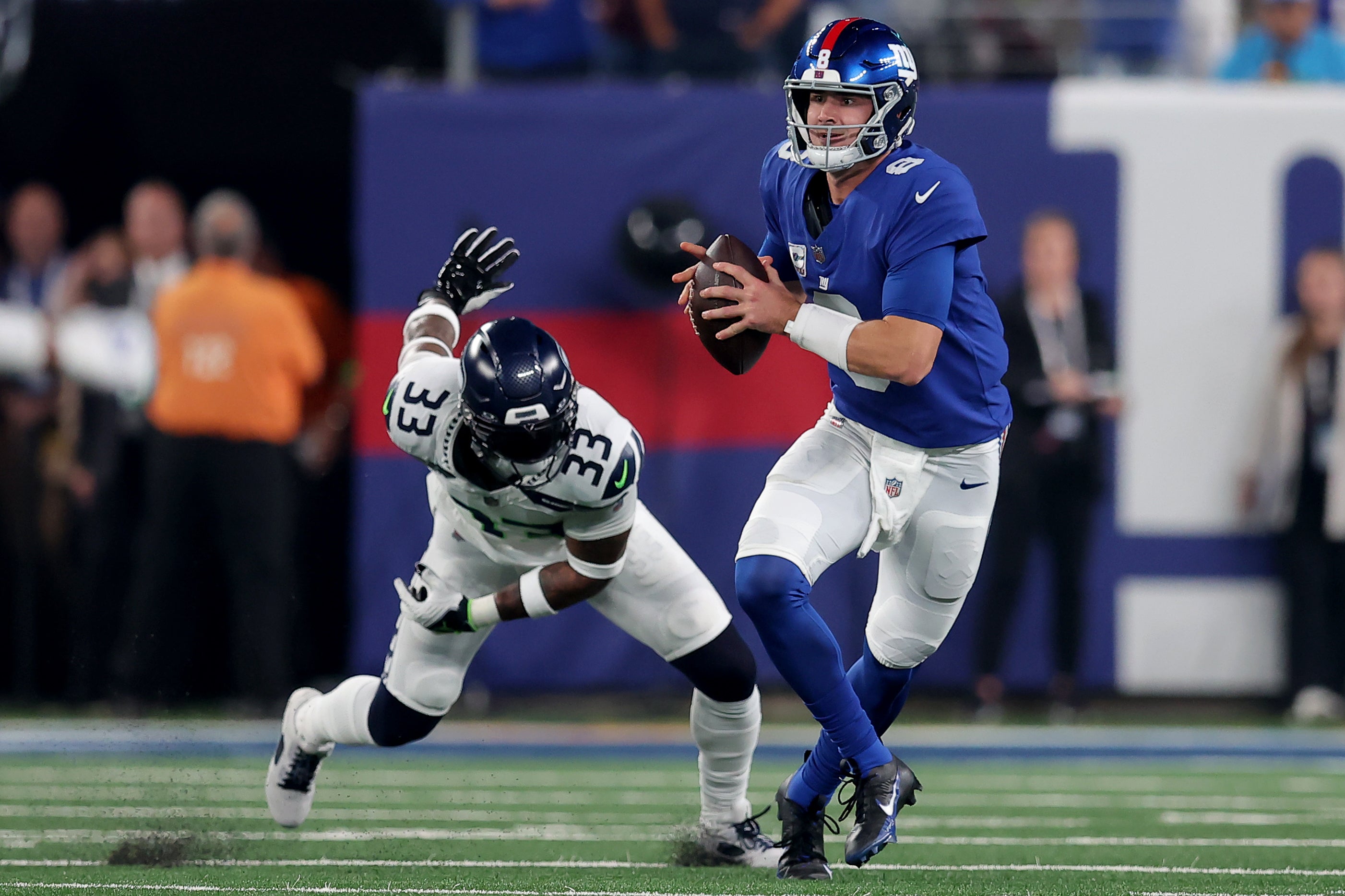 Oct 2, 2023; East Rutherford, New Jersey, USA; New York Giants quarterback Daniel Jones (8) looks to pass against Seattle Seahawks safety Jamal Adams (33) during the first quarter at MetLife Stadium. Mandatory Credit: Brad Penner-USA TODAY Sports