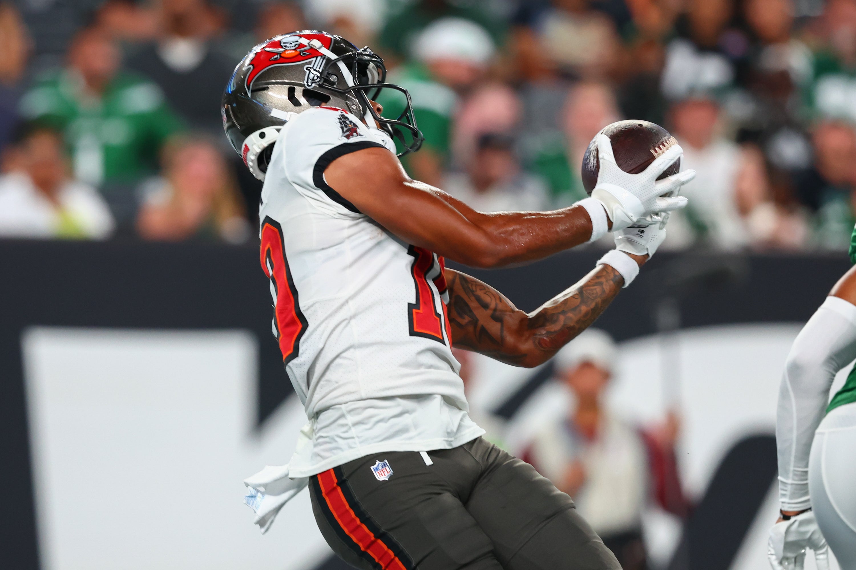 Aug 19, 2023; East Rutherford, New Jersey, USA; Tampa Bay Buccaneers wide receiver Trey Palmer (10) catches a touchdown pass against the New York Jets during the first half at MetLife Stadium. Mandatory Credit: Ed Mulholland-USA TODAY Sports