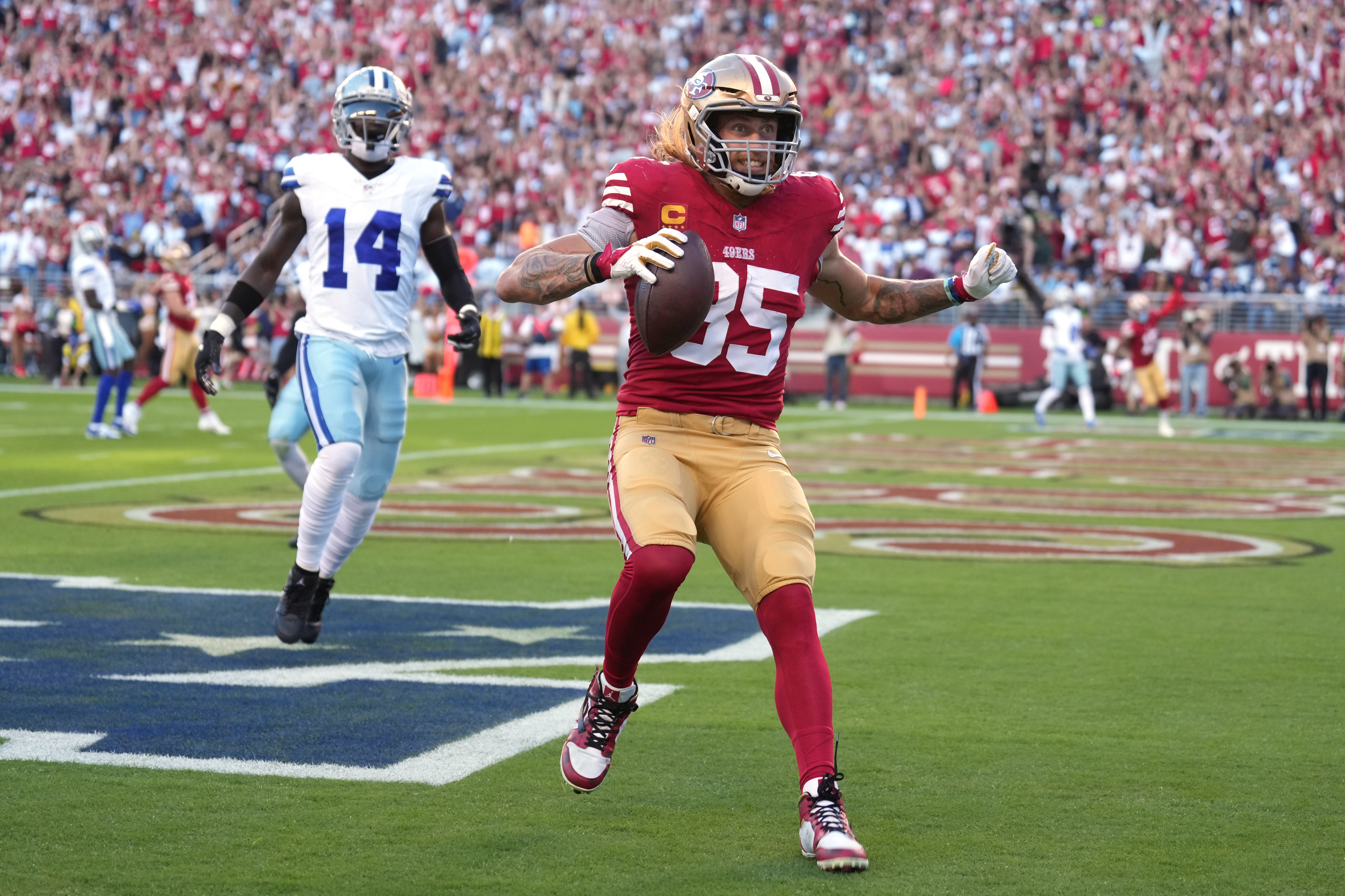 Oct 8, 2023; Santa Clara, California, USA; San Francisco 49ers tight end George Kittle (85) reacts after catching a touchdown pass against Dallas Cowboys safety Markquese Bell (14) during the first quarter at Levi's Stadium.