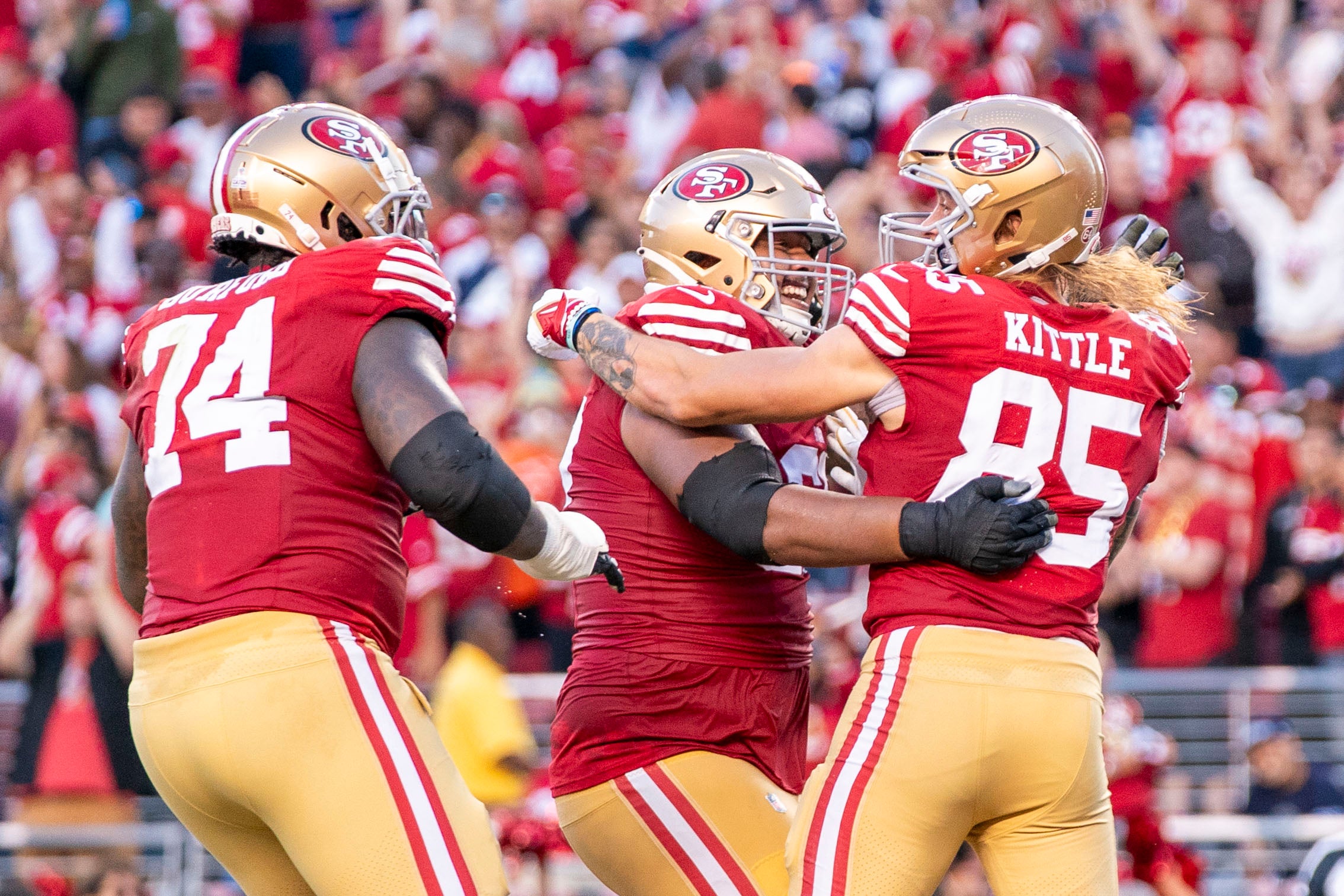 October 8, 2023; Santa Clara, California, USA; San Francisco 49ers tight end George Kittle (85) is congratulated by offensive tackle Spencer Burford (74) and guard Aaron Banks (65, center) for scoring a touchdown against the Dallas Cowboys during the second quarter at Levi's Stadium.