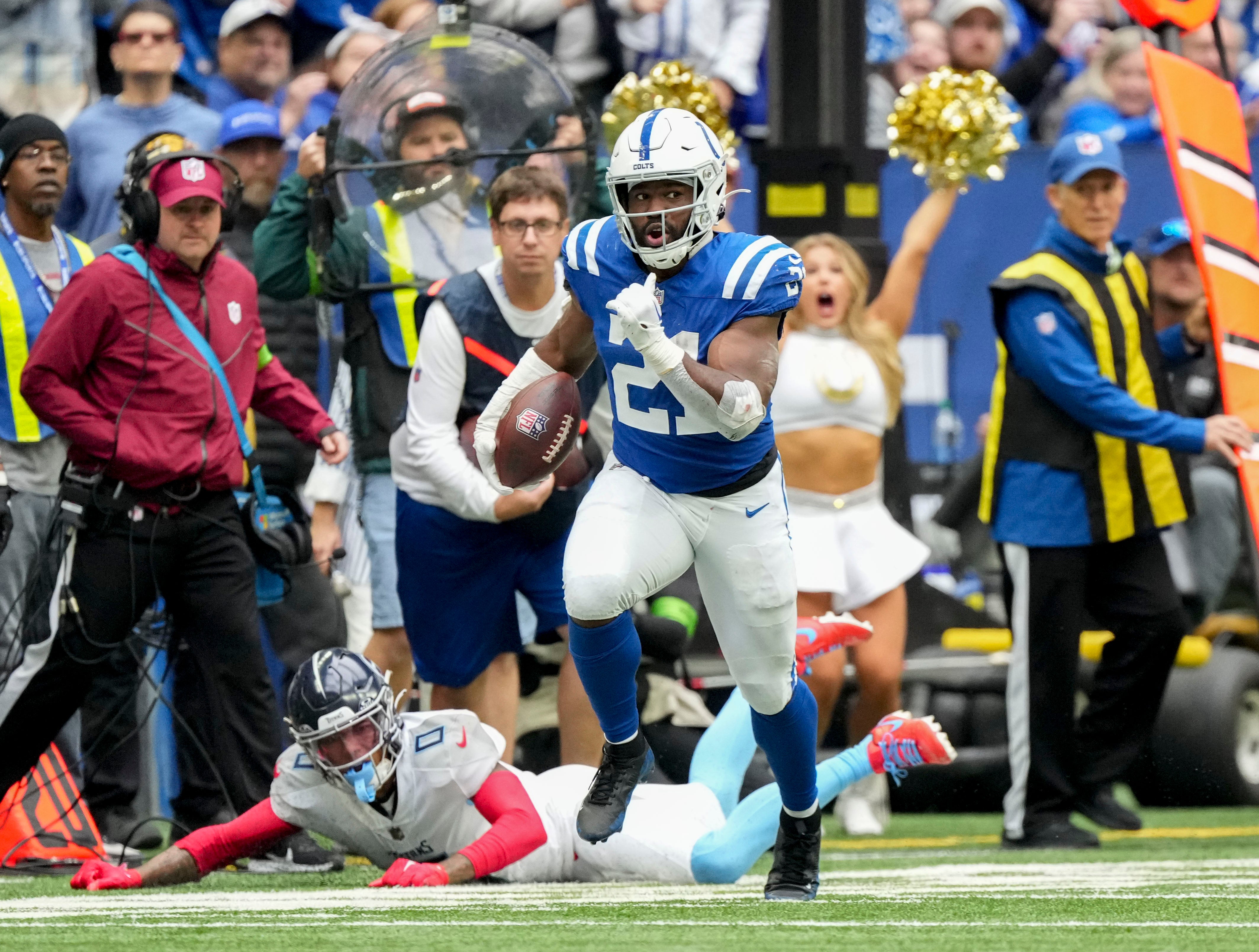 Oct 8, 2023; Indianapolis, Indiana, USA; Indianapolis Colts running back Zack Moss (21) rushes the ball during a game against the Tennessee Titans at Lucas Oil Stadium.