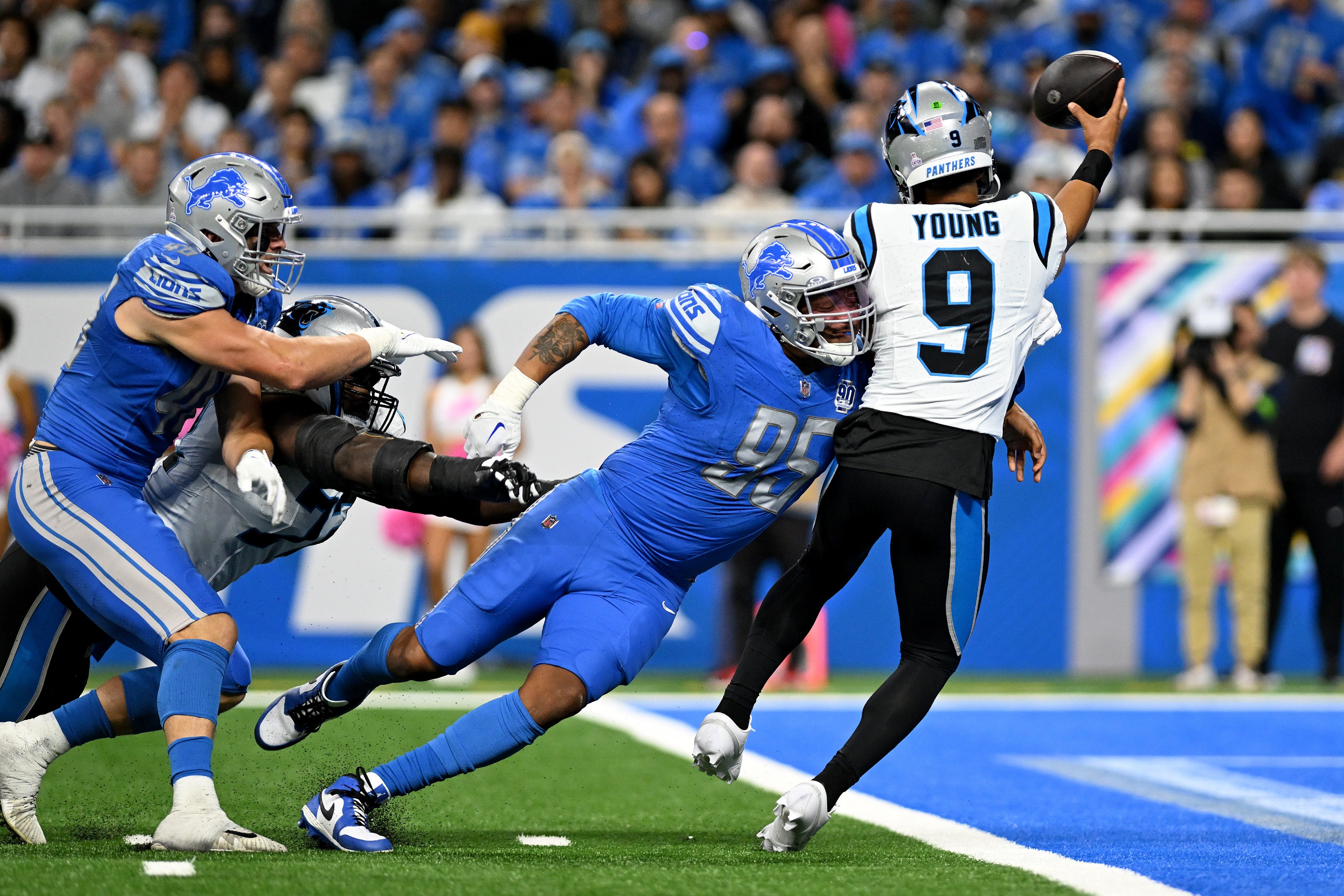 Oct 8, 2023; Detroit, Michigan, USA; Detroit Lions defensive end Romeo Okwara (95) nearly sacks Carolina Panthers quarterback Bryce Young (9) in the end zone in the third quarter at Ford Field. Okwara forced Young into an intentional grounding penalty on the play. Mandatory Credit: Lon Horwedel-USA TODAY Sports