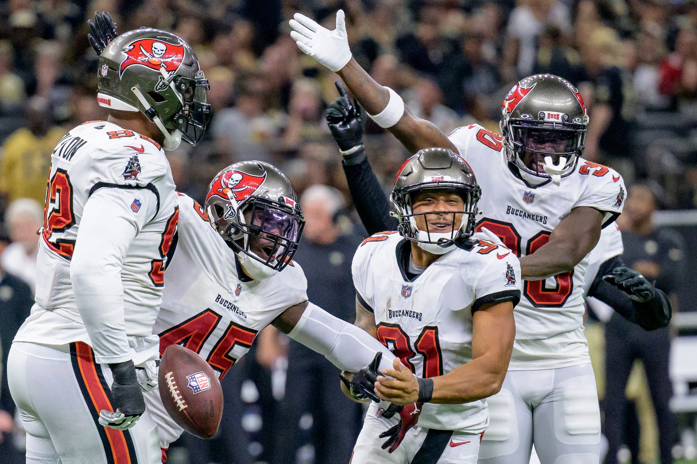 Oct 1, 2023; New Orleans, Louisiana, USA; Tampa Bay Buccaneers safety Antoine Winfield Jr. (31) and other players celebrate a fumble caused by Winfield against New Orleans Saints fullback Adam Prentice (46) during the second quarter at the Caesars Superdome. Mandatory Credit: Matthew Hinton-USA TODAY Sports