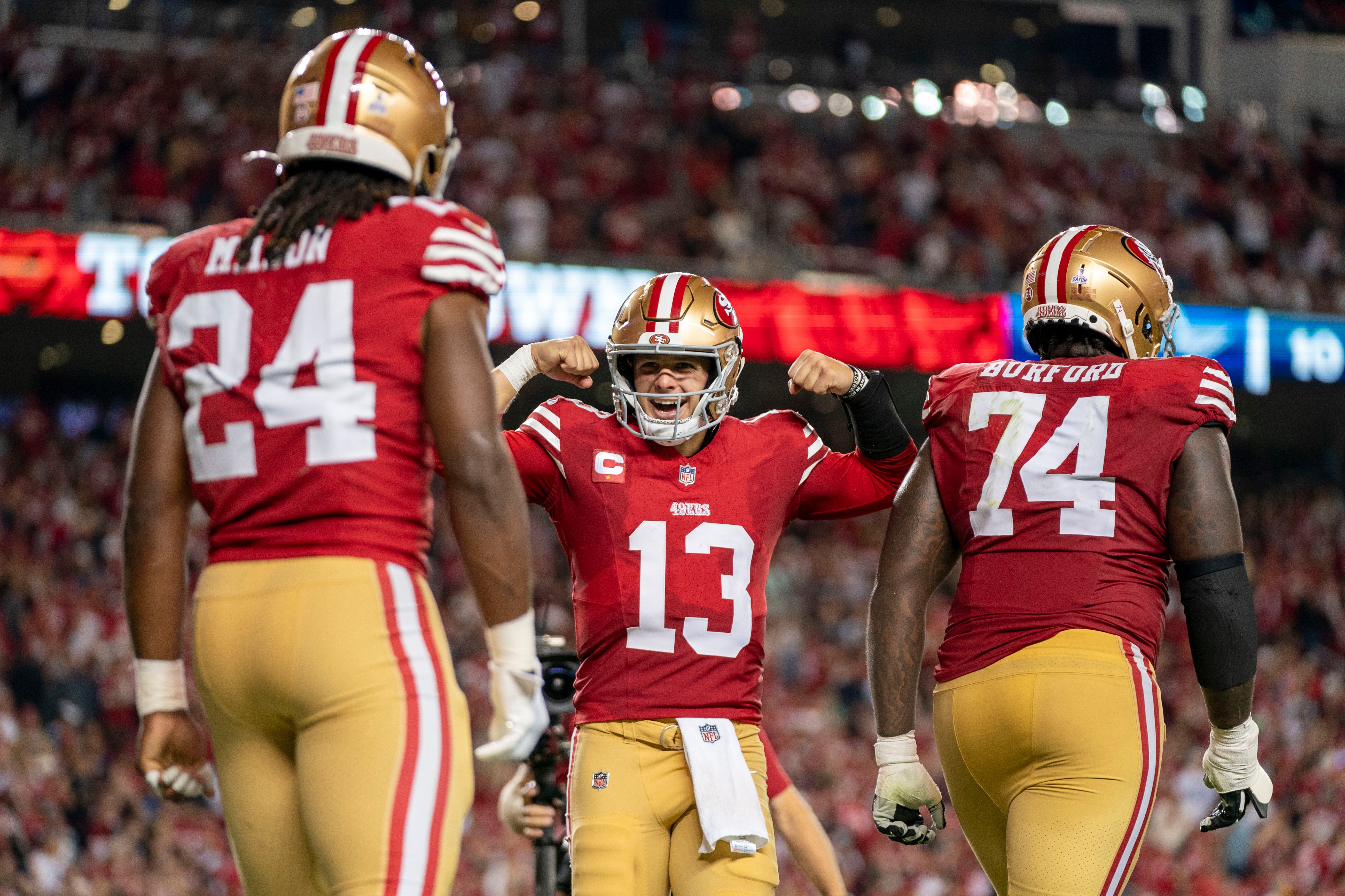 October 8, 2023; Santa Clara, California, USA; San Francisco 49ers quarterback Brock Purdy (13) celebrates with running back Jordan Mason (24) after a touchdown against the Dallas Cowboys during the fourth quarter at Levi's Stadium.