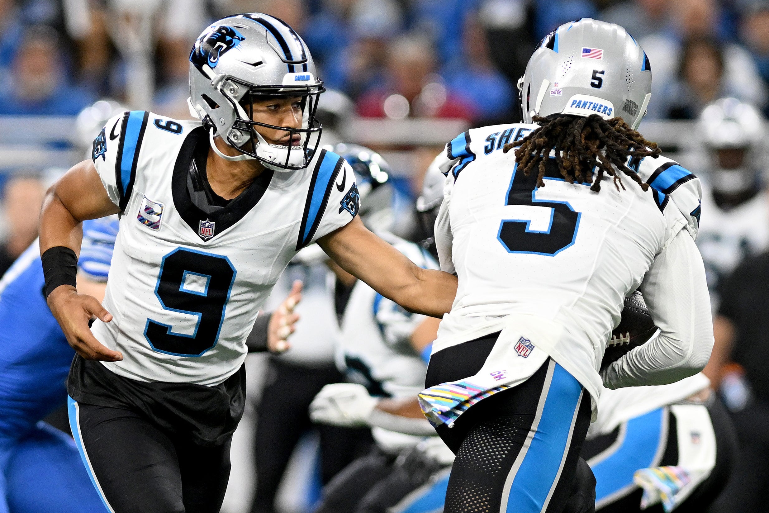 Oct 8, 2023; Detroit, Michigan, USA; Carolina Panthers quarterback Bryce Young (9) hands the ball to wide receiver Laviska Shenault Jr. (5) against the Detroit Lions in the first quarter at Ford Field. Mandatory Credit: Lon Horwedel-USA TODAY Sports