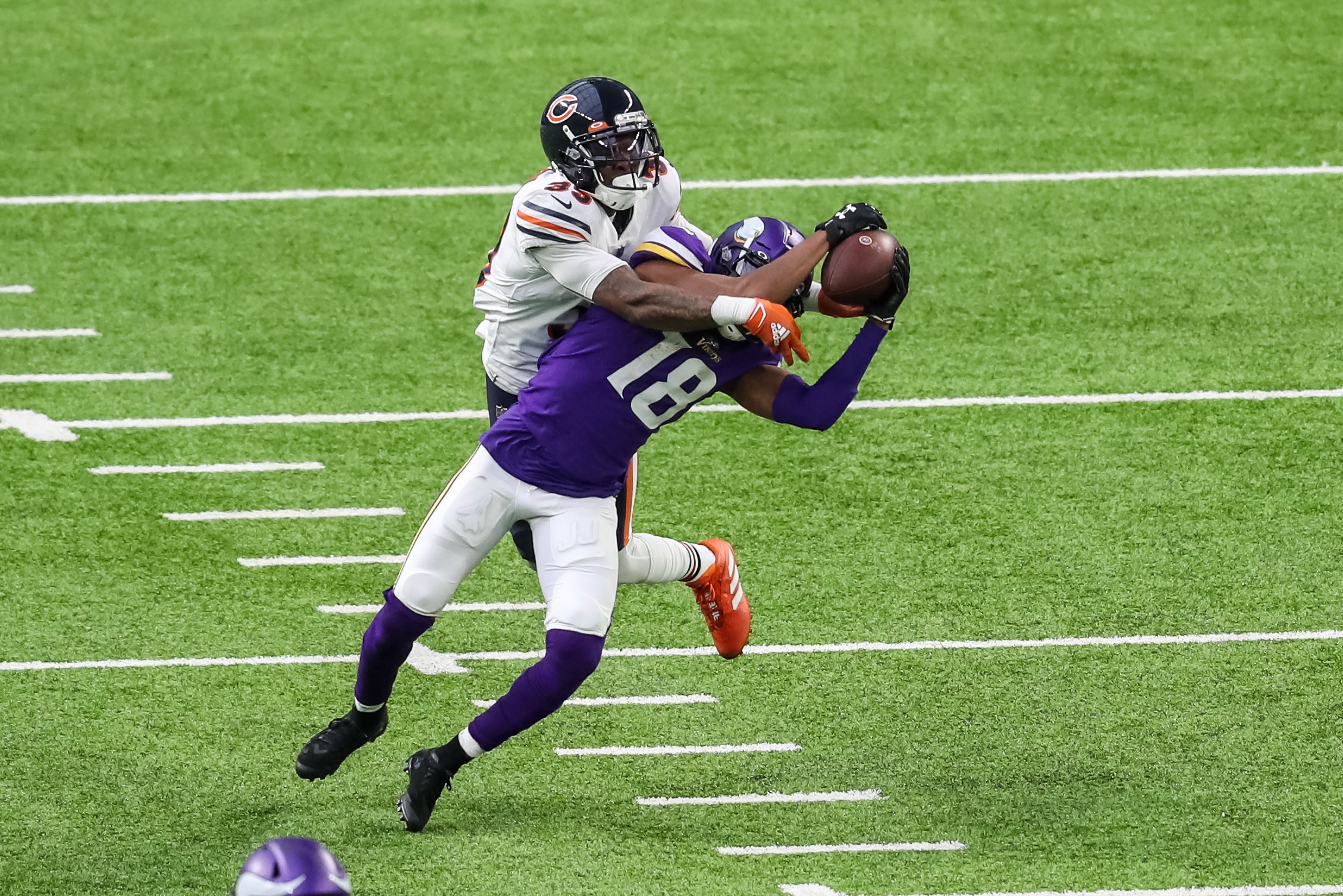 Dec 20, 2020; Minneapolis, Minnesota, USA; Minnesota Vikings wide receiver Justin Jefferson (18) makes a catch in front of Chicago Bears safety Eddie Jackson (39) during the fourth quarter at U.S. Bank Stadium.