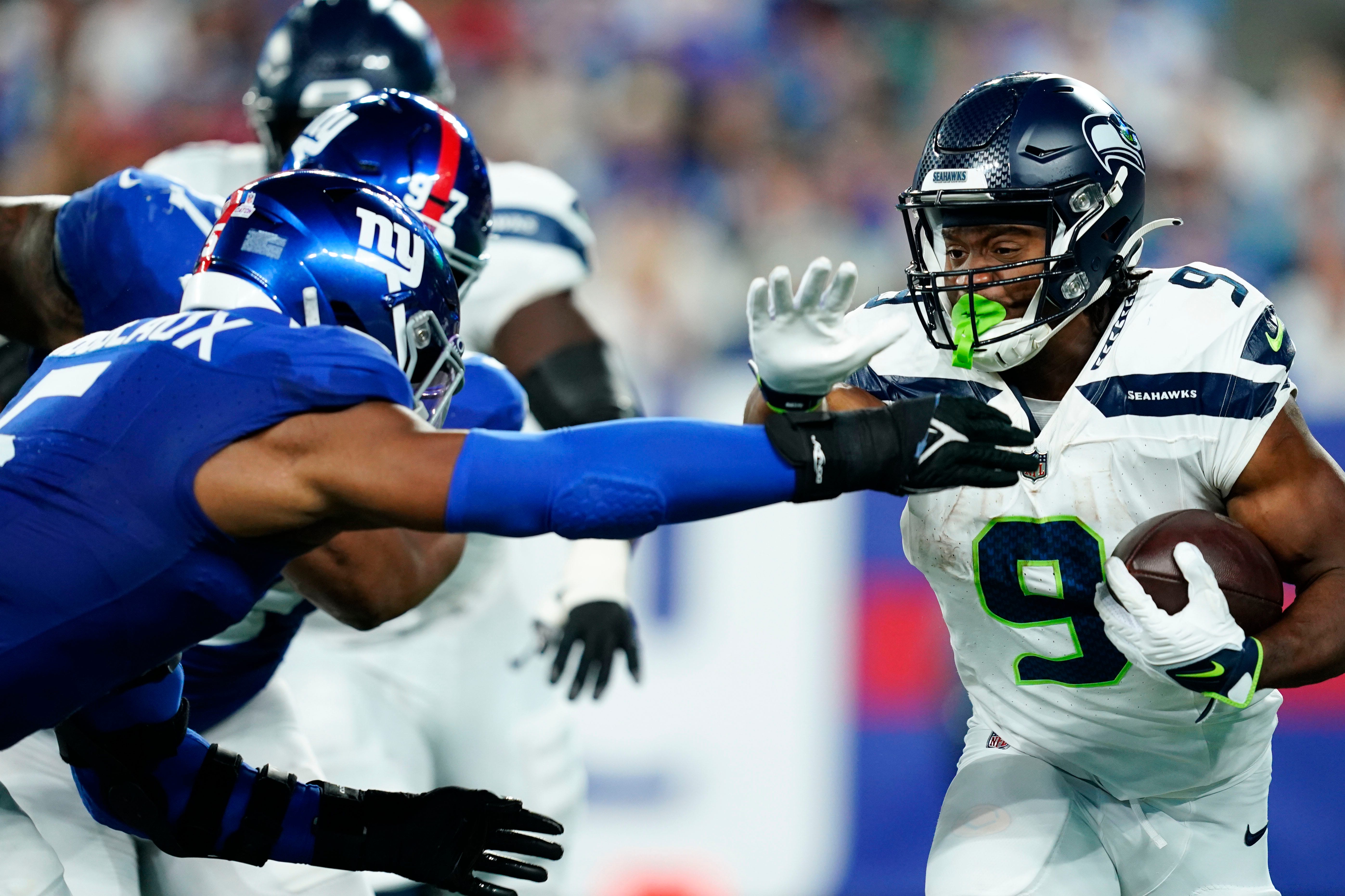 Seattle Seahawks running back Kenneth Walker III (9) rushes with pressure from New York Giants linebacker Kayvon Thibodeaux (5) in the first half at MetLife Stadium on Monday, Oct. 2, 2023, in East Rutherford.