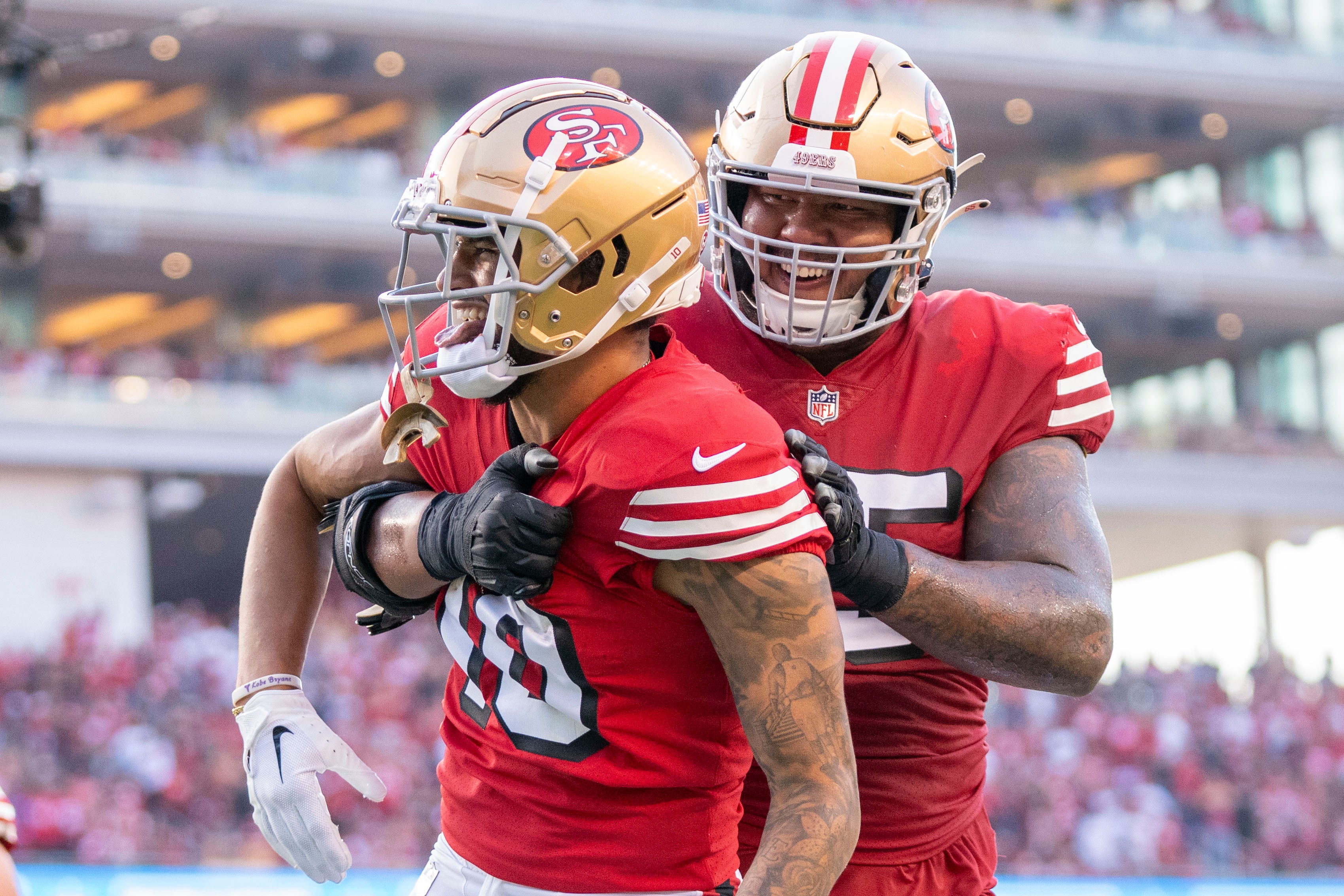 September 21, 2023; Santa Clara, California, USA; San Francisco 49ers wide receiver Ronnie Bell (10) is congratulated by guard Aaron Banks (65) after scoring a touchdown against the New York Giants during the second quarter at Levi's Stadium.