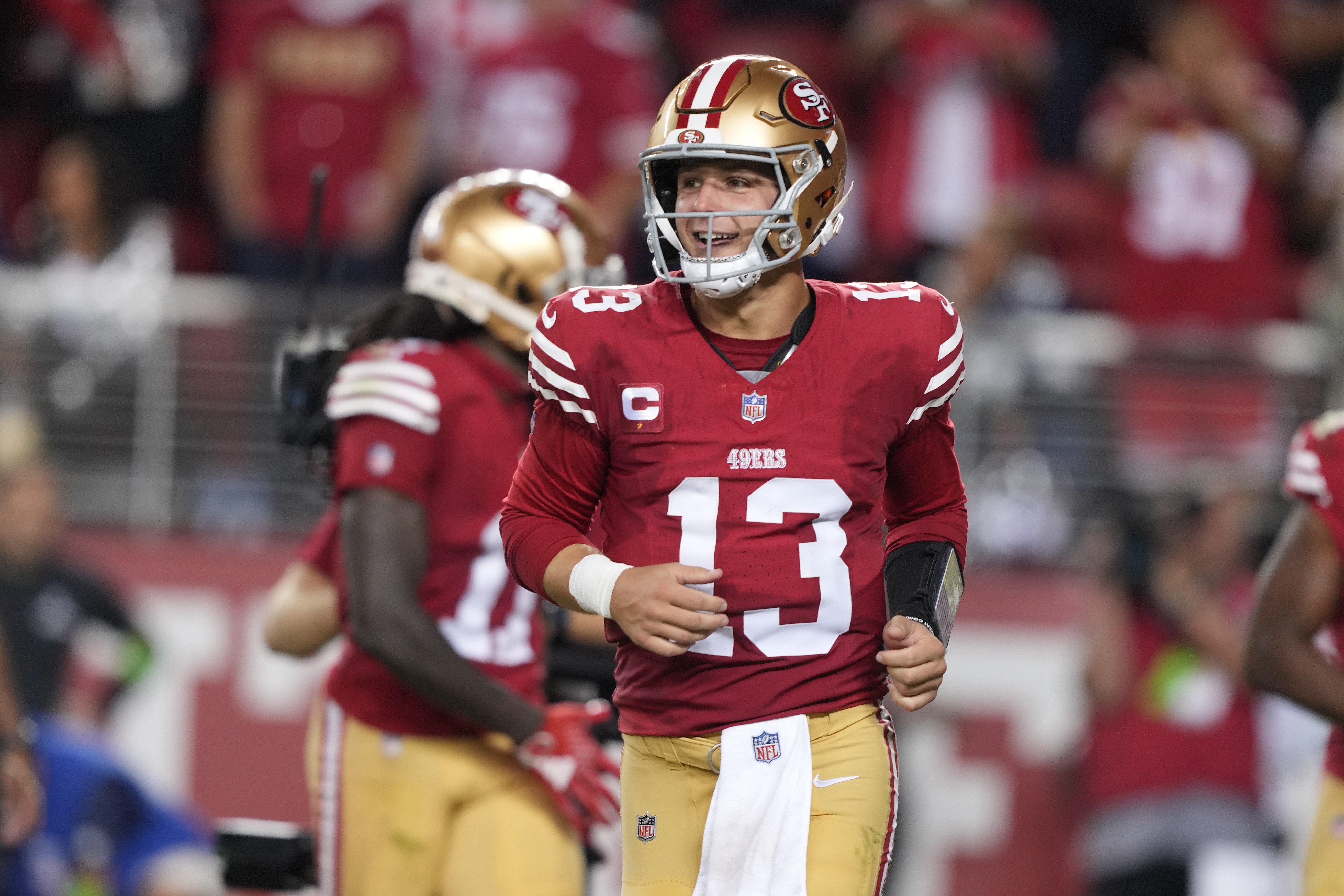 Oct 8, 2023; Santa Clara, California, USA; San Francisco 49ers quarterback Brock Purdy (13) jogs off of the field after a touchdown by running back Jordan Mason (not shown) during the fourth quarter at Levi's Stadium.