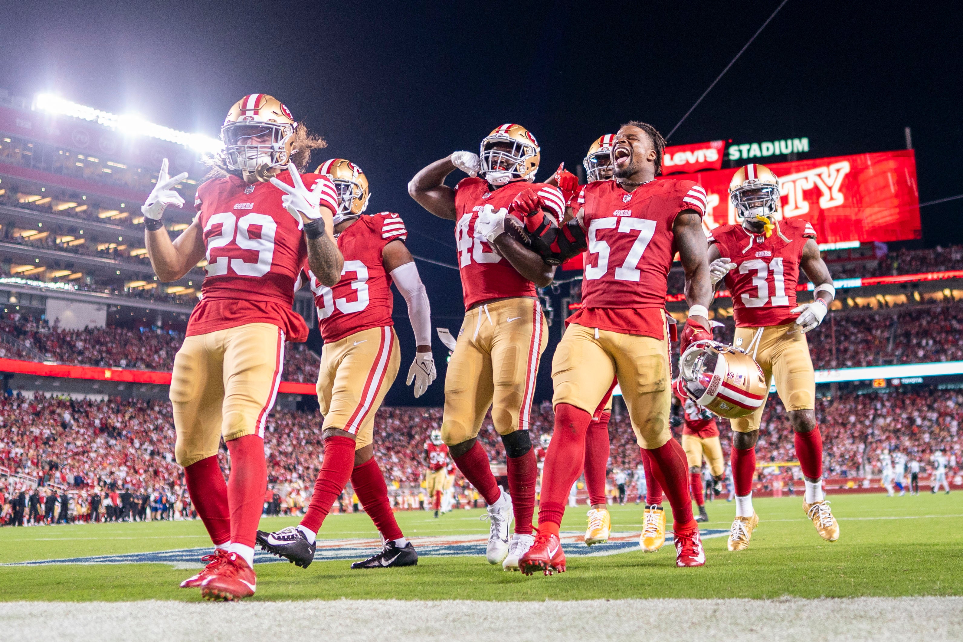 October 8, 2023; Santa Clara, California, USA; San Francisco 49ers linebacker Oren Burks (48) celebrates with teammates after intercepting the football against the Dallas Cowboys during the fourth quarter at Levi's Stadium.