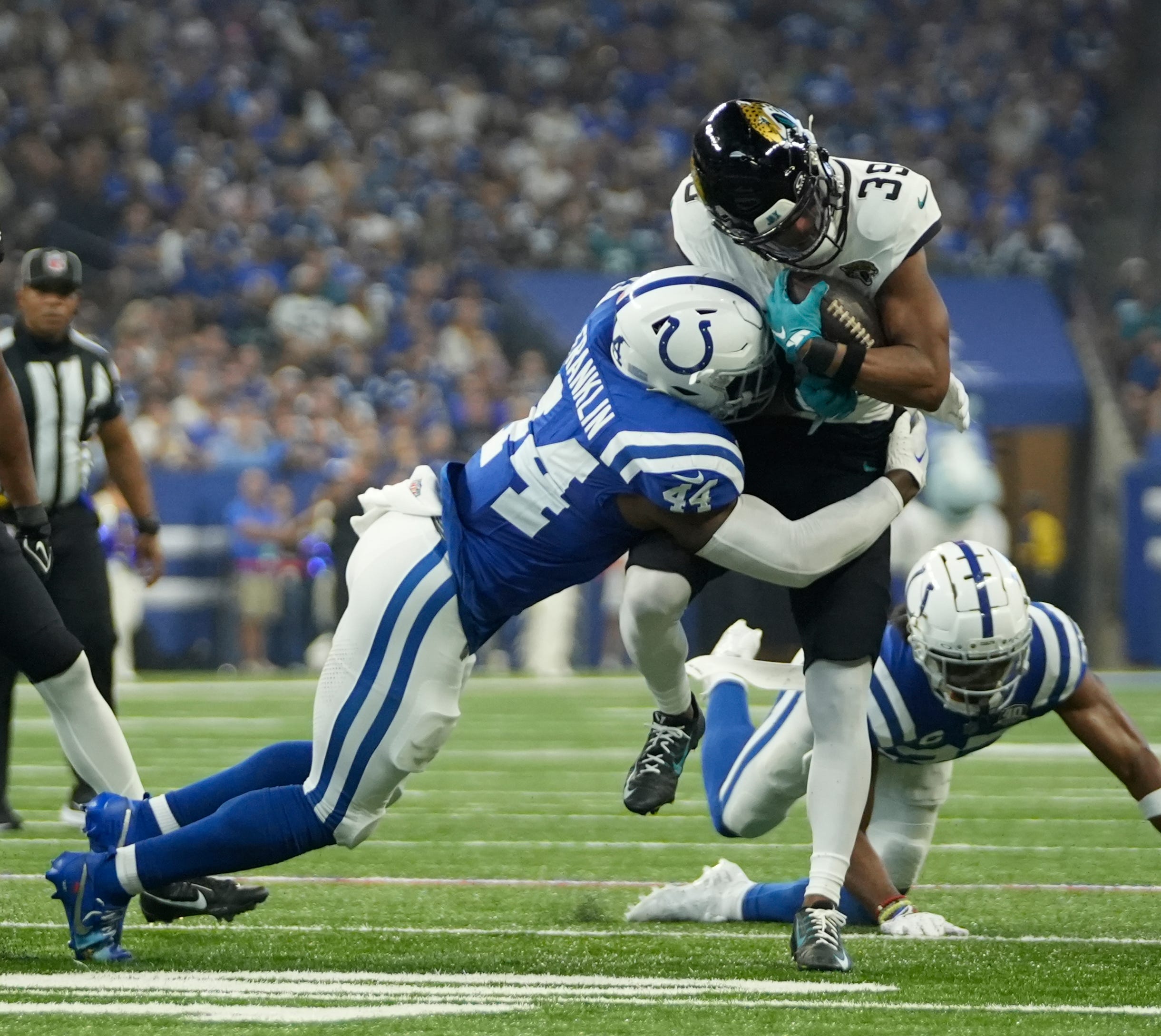 Indianapolis Colts linebacker Zaire Franklin (44) tackles Jacksonville Jaguars wide receiver Jamal Agnew (39), during a game against the Jacksonville Jaguars at Lucas Oil Stadium in Indianapolis.