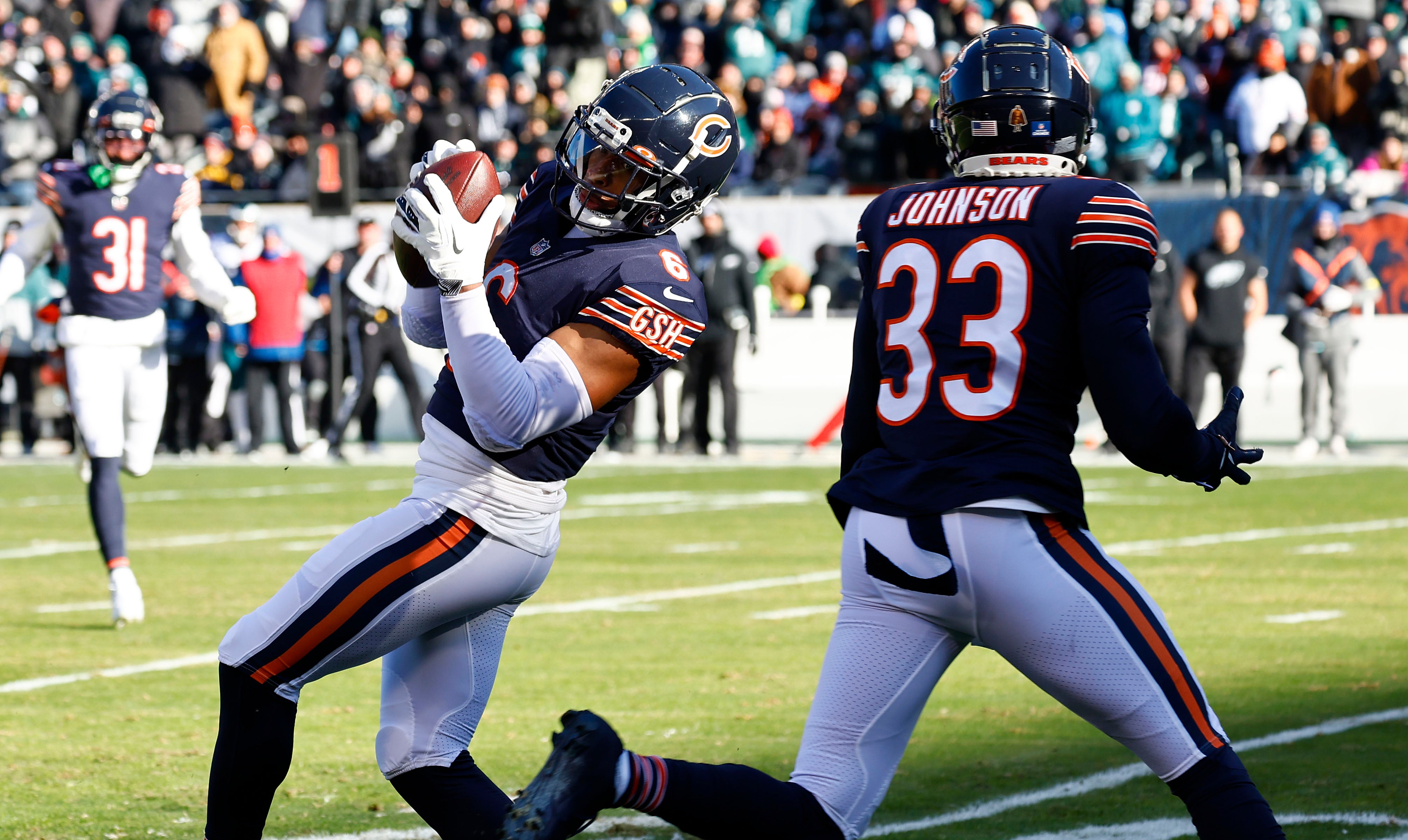 Dec 18, 2022; Chicago, Illinois, USA; Chicago Bears cornerback Kyler Gordon (6) makes an interception against the Philadelphia Eagles during the first quarter at Soldier Field.