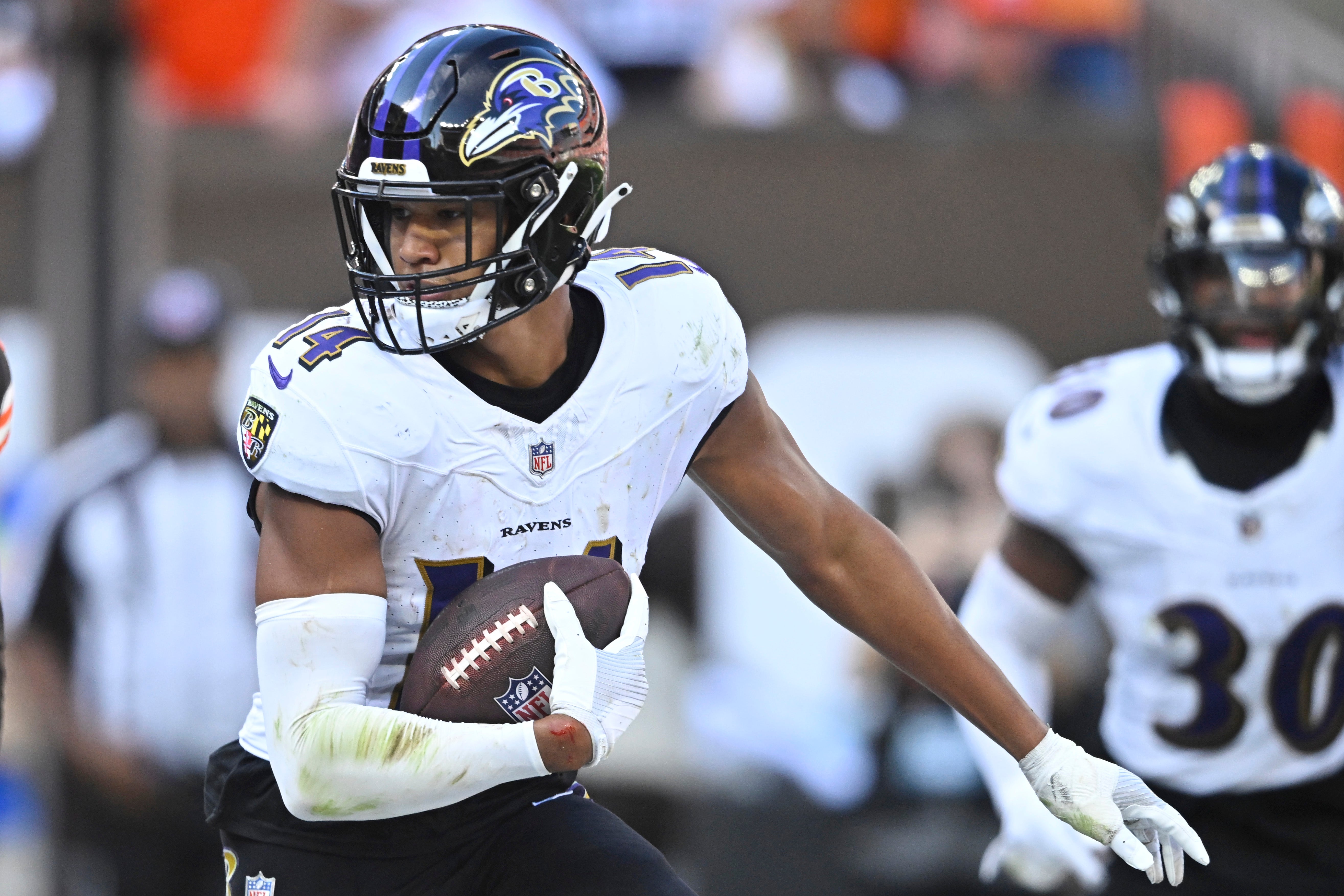 Baltimore Ravens safety Kyle Hamilton (14) runs after intercepting a pass in the fourth quarter against the Cleveland Browns at Cleveland Browns Stadium.