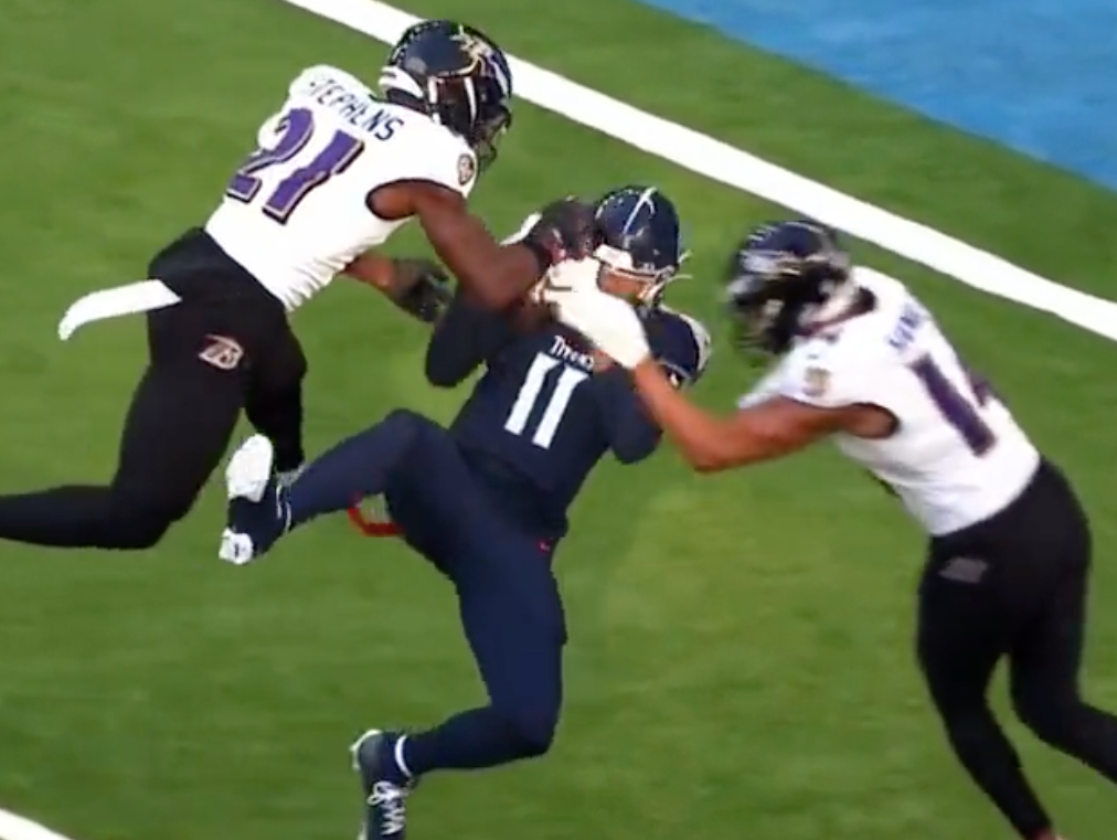 Titans wide receiver Chris Moore takes a hit from Kyle Hamilton.