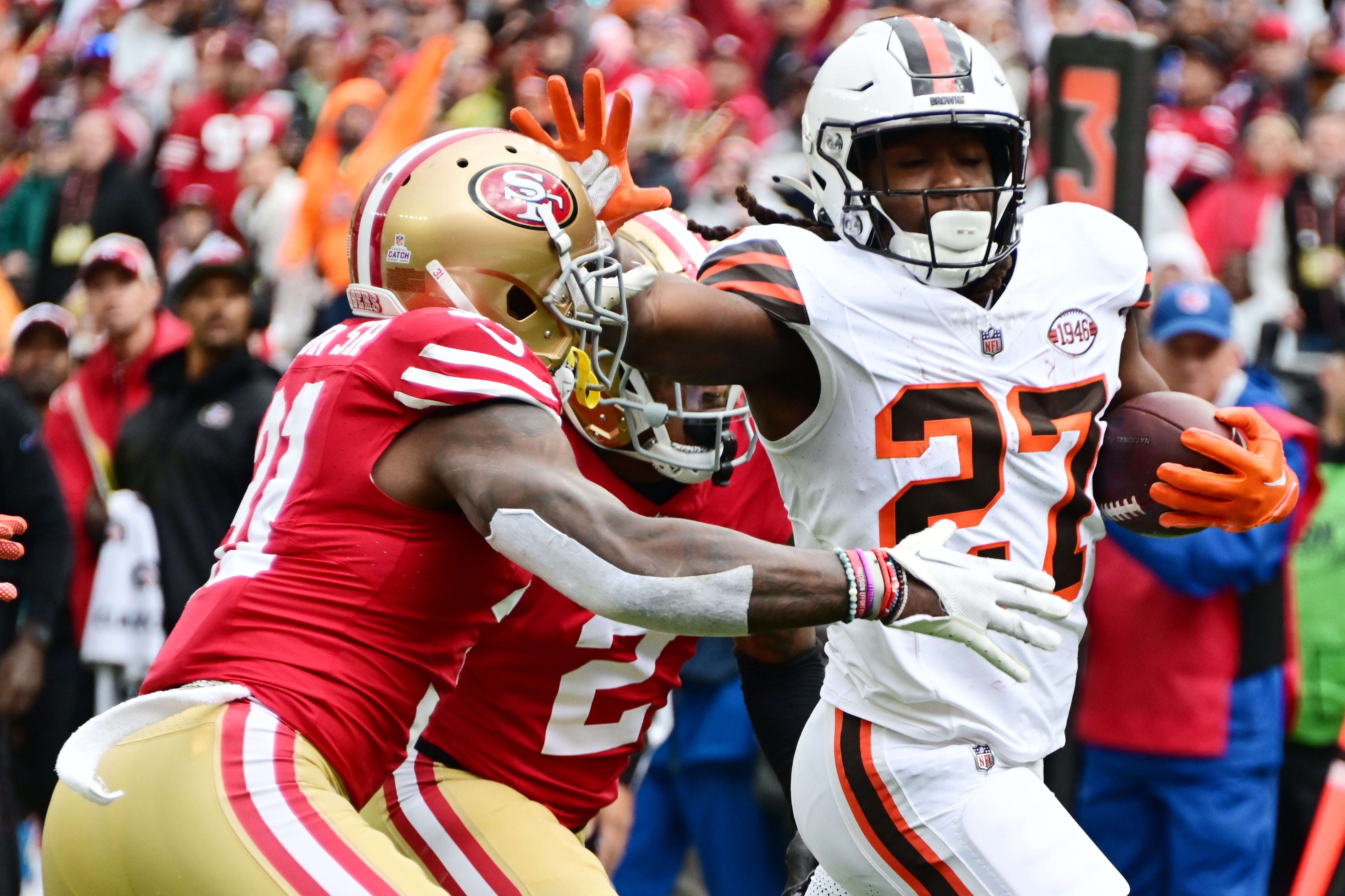 Oct 15, 2023; Cleveland, Ohio, USA; Cleveland Browns running back Kareem Hunt (27) scores a touchdown as San Francisco 49ers safety Tashaun Gipson Sr. (31) and cornerback Deommodore Lenoir (2) defend during the first half at Cleveland Browns Stadium.