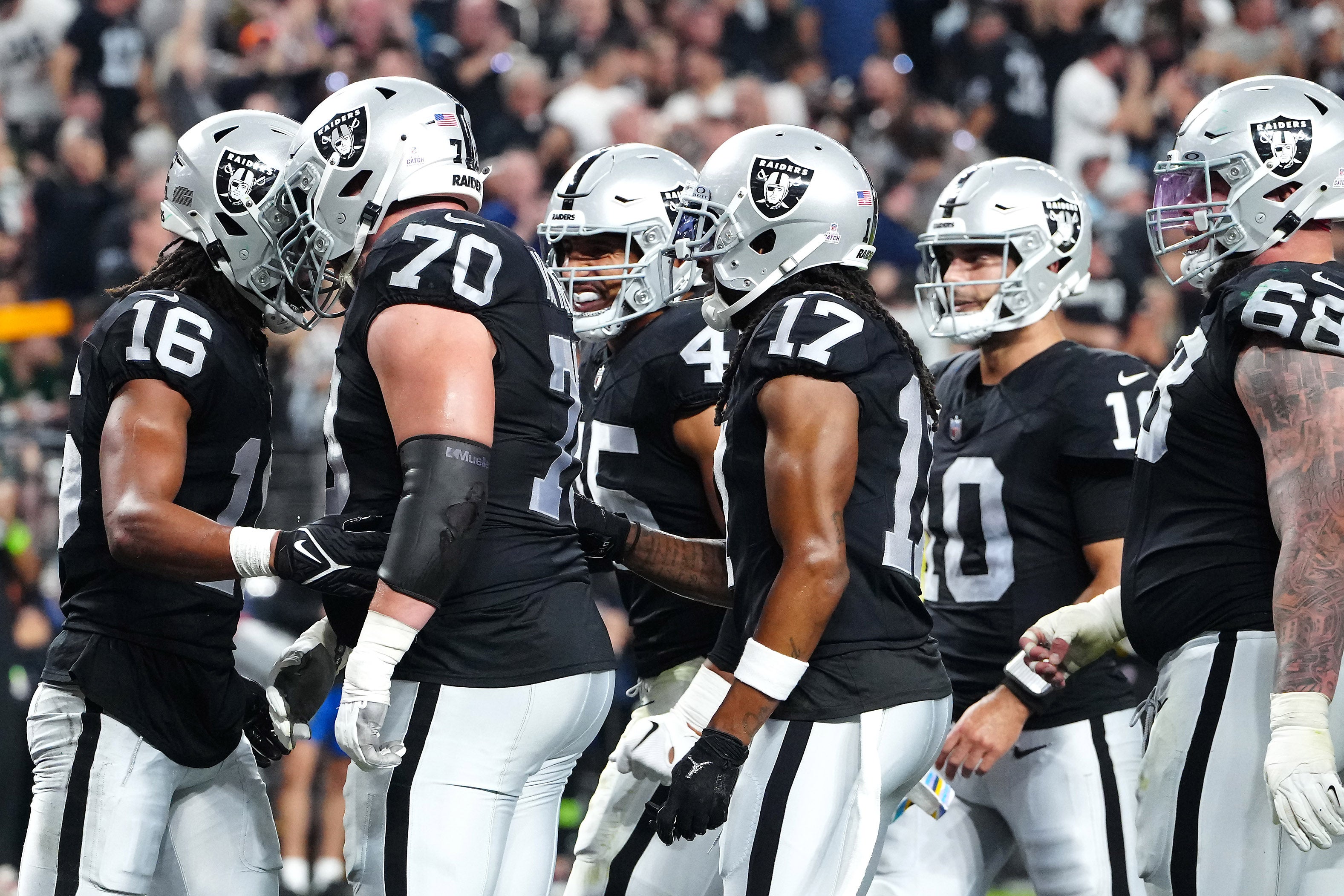 Oct 9, 2023; Paradise, Nevada, USA; Las Vegas Raiders wide receiver Jakobi Meyers (16) celebrates with team mates after scoring a touchdown against the Green Bay Packers during the second quarter at Allegiant Stadium.
