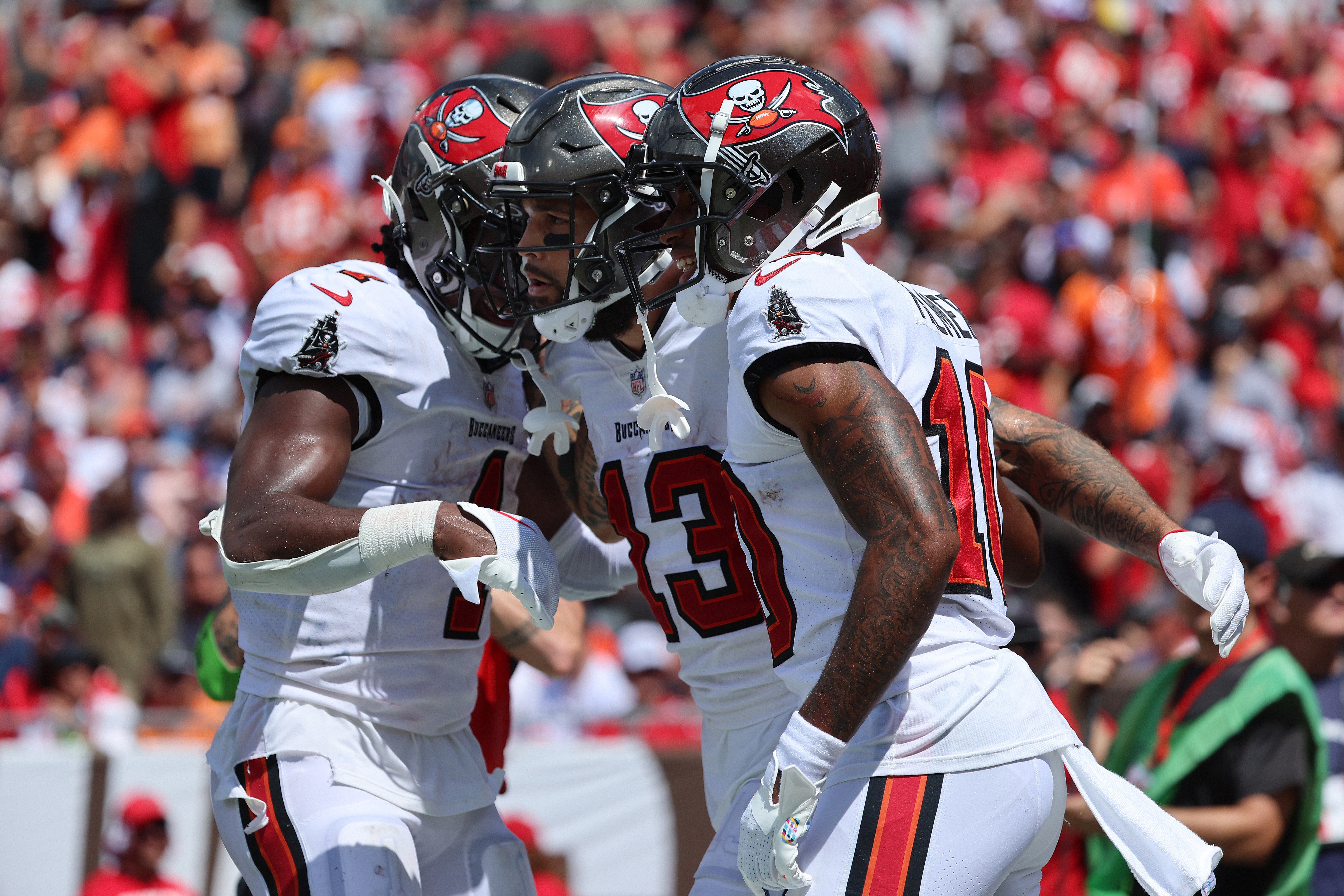 Sep 17, 2023; Tampa, Florida, USA; Tampa Bay Buccaneers wide receiver Mike Evans (13) is congratulated by teammates after scoring a touchdown against the Chicago Bears during the second half at Raymond James Stadium. Mandatory Credit: Kim Klement Neitzel-USA TODAY Sports