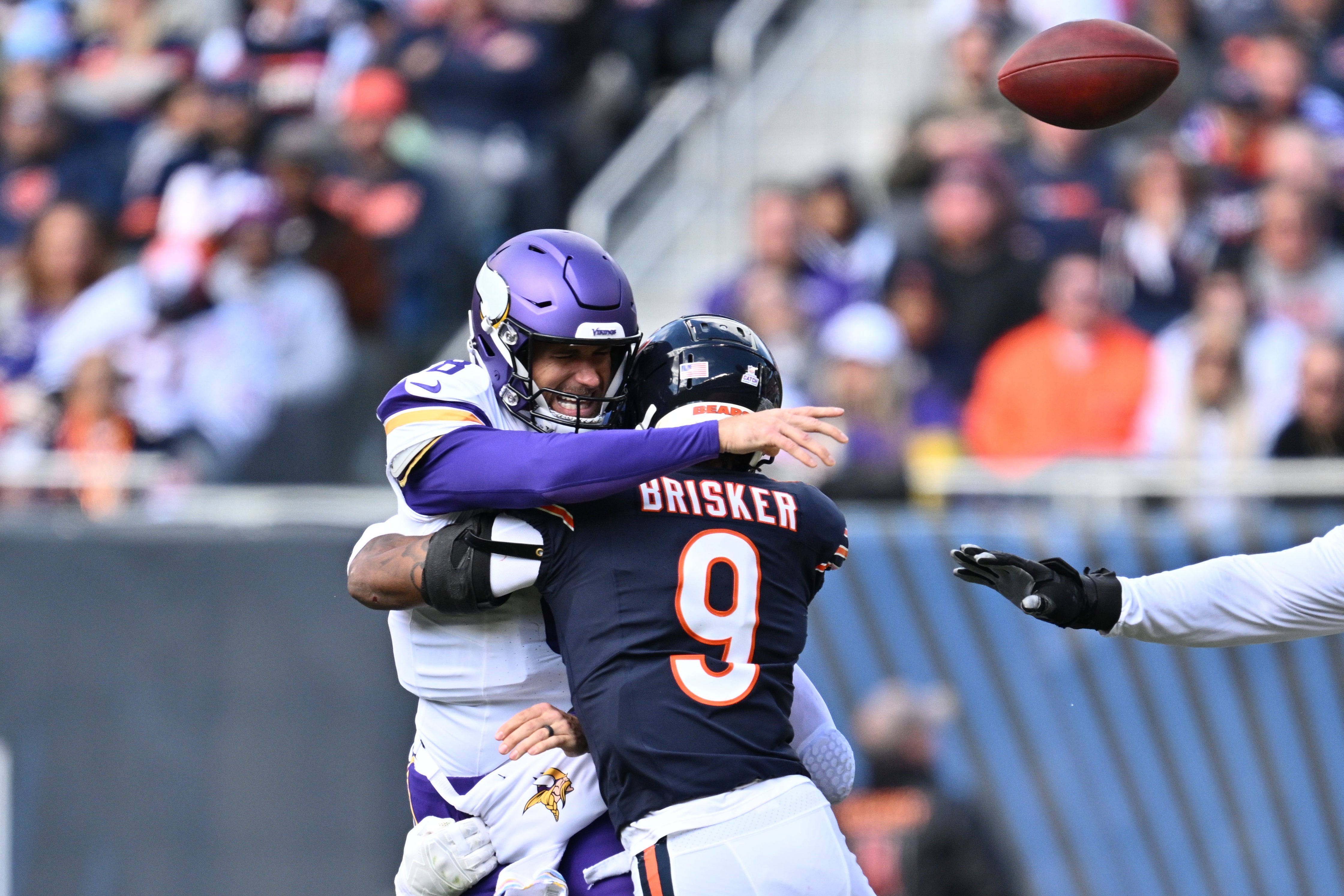 Oct 15, 2023; Chicago, Illinois, USA; Minnesota Vikings quarterback Kirk Cousins (8) is hit by Chicago Bears defensive back Jaquan Brisker (9) causing a backwards pass for fumble in the first half at Soldier Field.