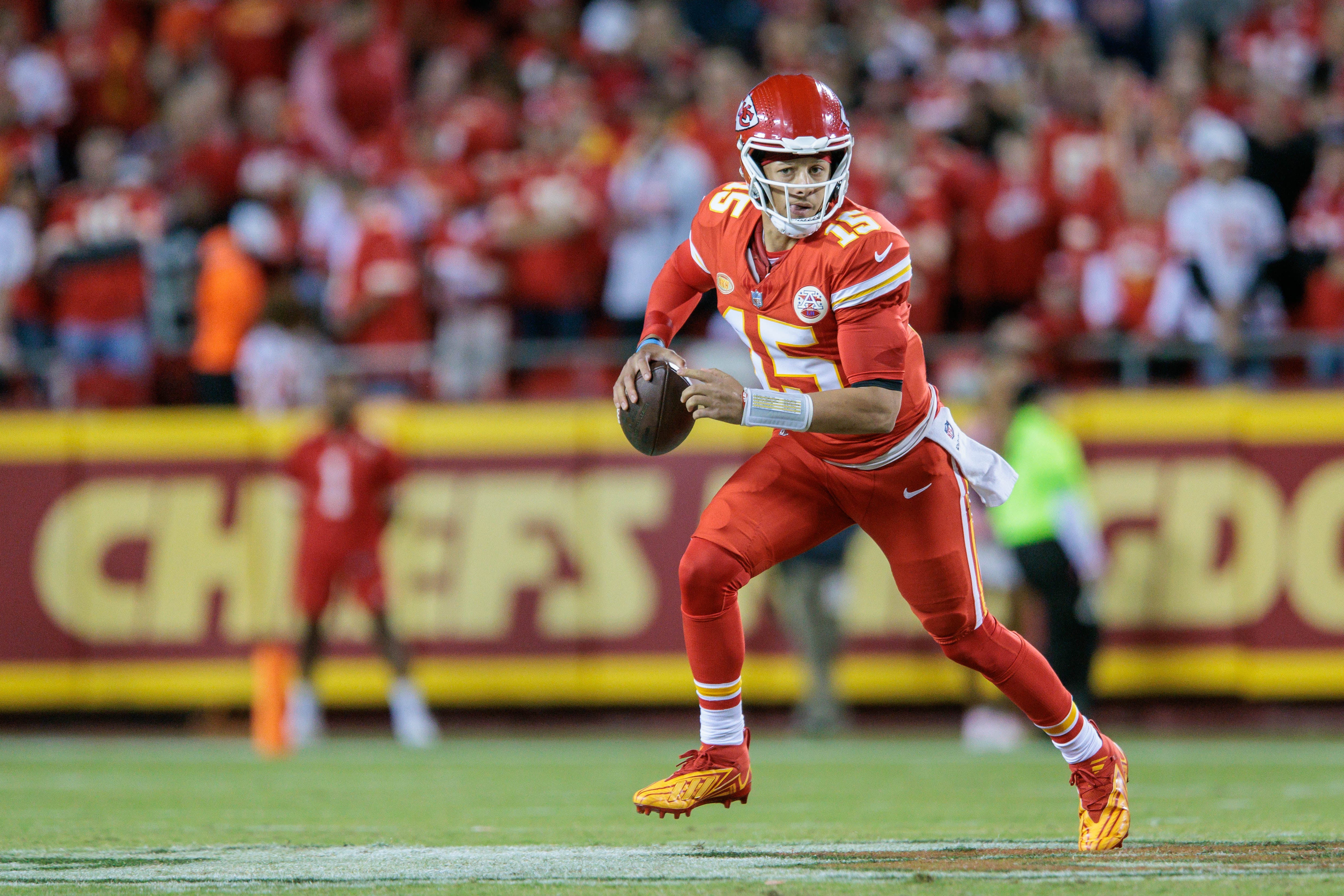 Kansas City Chiefs quarterback Patrick Mahomes (15) scrambles in the back field during the second quarter against the Denver Broncos at GEHA Field at Arrowhead Stadium. Mandatory Credit: William Purnell-USA TODAY Sports
