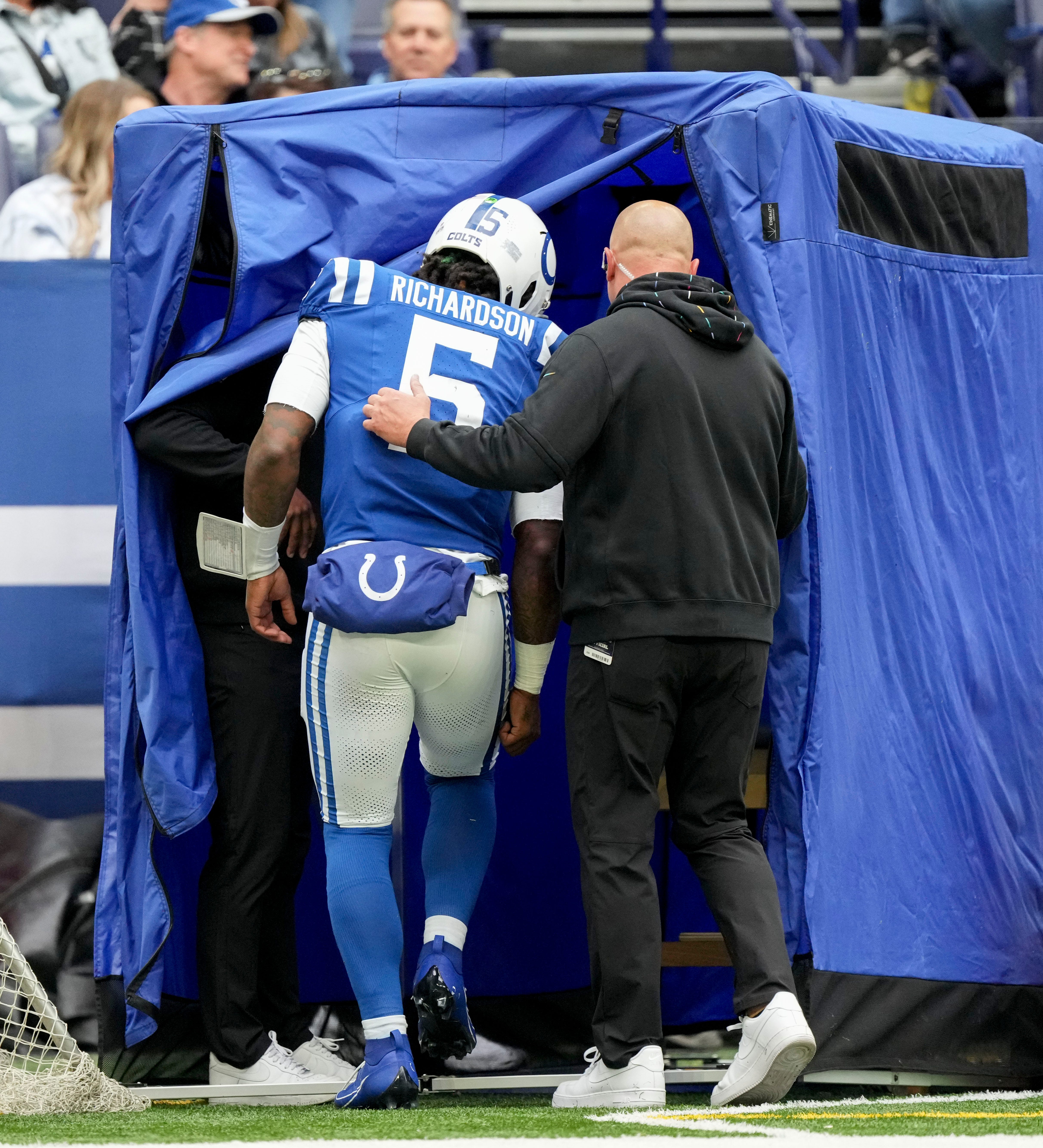 Indianapolis Colts quarterback Anthony Richardson (5) is led into the blue tent after injuring his shoulder Sunday, Oct. 8, 2023, during a game against the Tennessee Titans at Lucas Oil Stadium in Indianapolis.