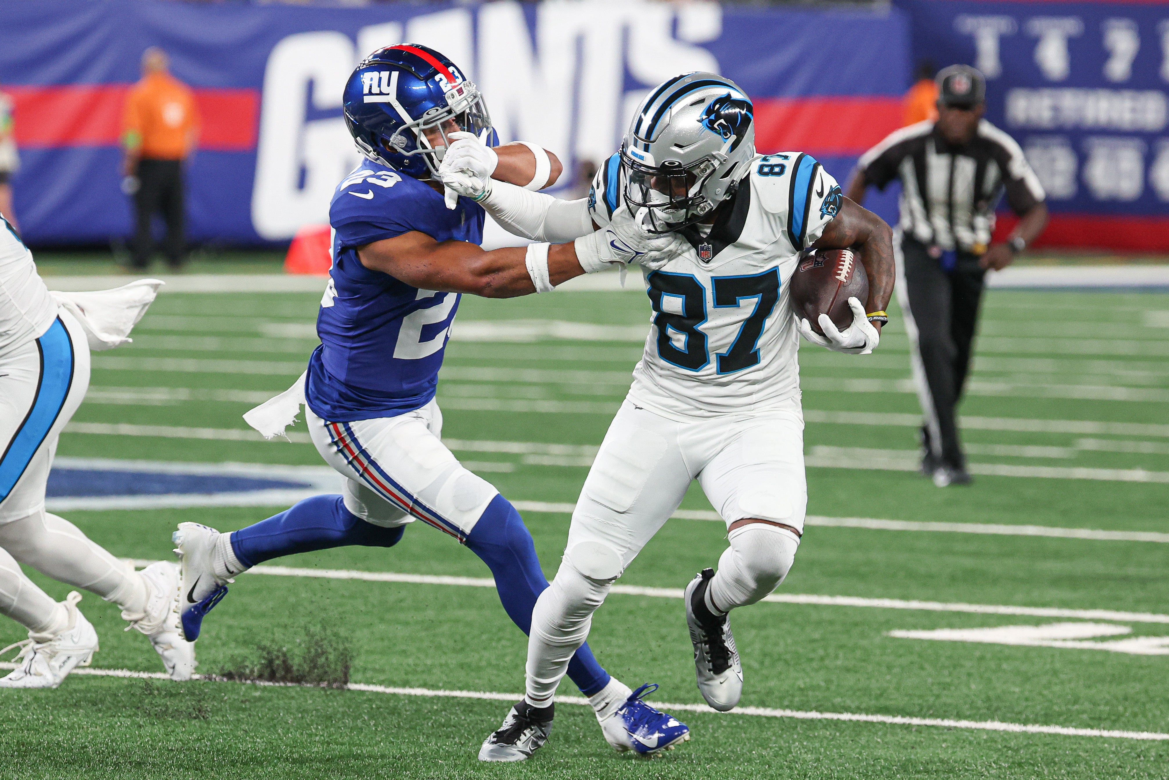 Aug 18, 2023; East Rutherford, New Jersey, USA; Carolina Panthers wide receiver Josh Vann (87) battles for yards against New York Giants safety Alex Cook (23) during the second half at MetLife Stadium. Mandatory Credit: Vincent Carchietta-USA TODAY Sports