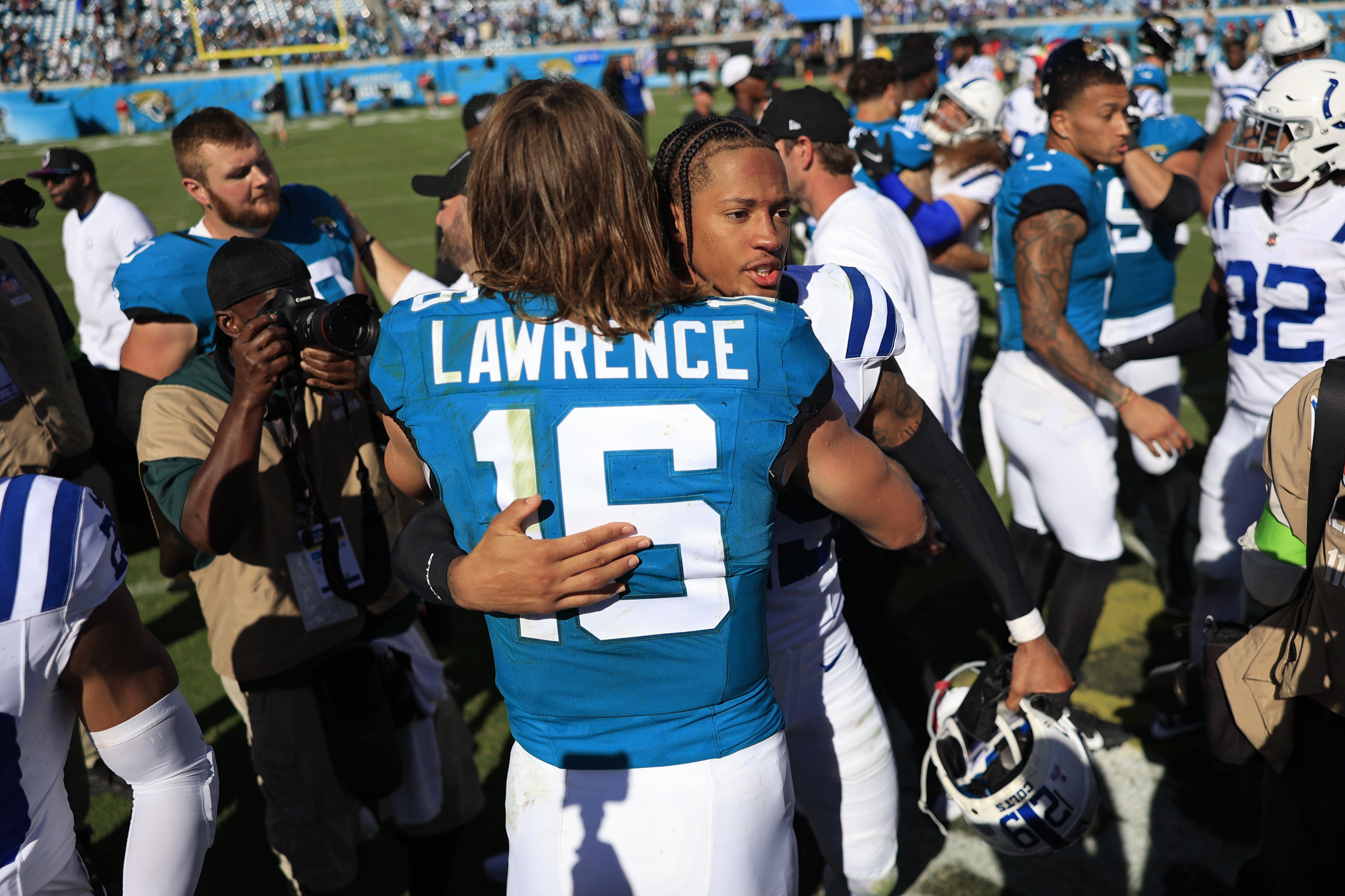 Jacksonville Jaguars quarterback Trevor Lawrence (16) hugs Indianapolis Colts cornerback JuJu Brents (29) after the game an NFL football matchup Sunday, Oct. 15, 2023 at EverBank Stadium in Jacksonville, Fla. The Jacksonville Jaguars defeated the Indianapolis Colts 37-20.
