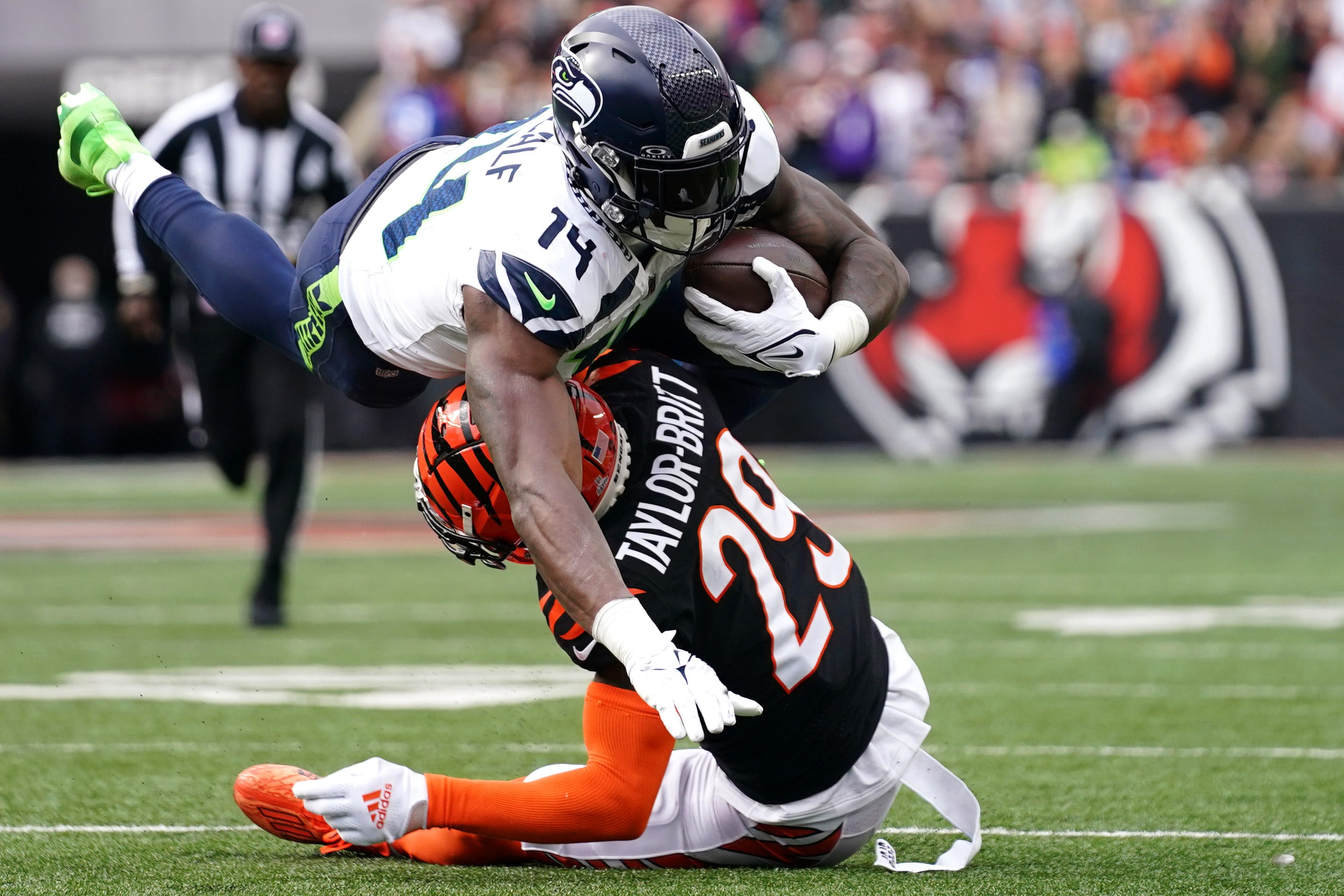 Cincinnati Bengals cornerback Cam Taylor-Britt (29) tackles Seattle Seahawks wide receiver DK Metcalf (14) following a catch in the fourth quarter during an NFL football game between the Seattle Seahawks and the Cincinnati Bengals Sunday, Oct. 15, 2023, at Paycor Stadium in Cincinnati. The Cincinnati Bengals won, 17-13.