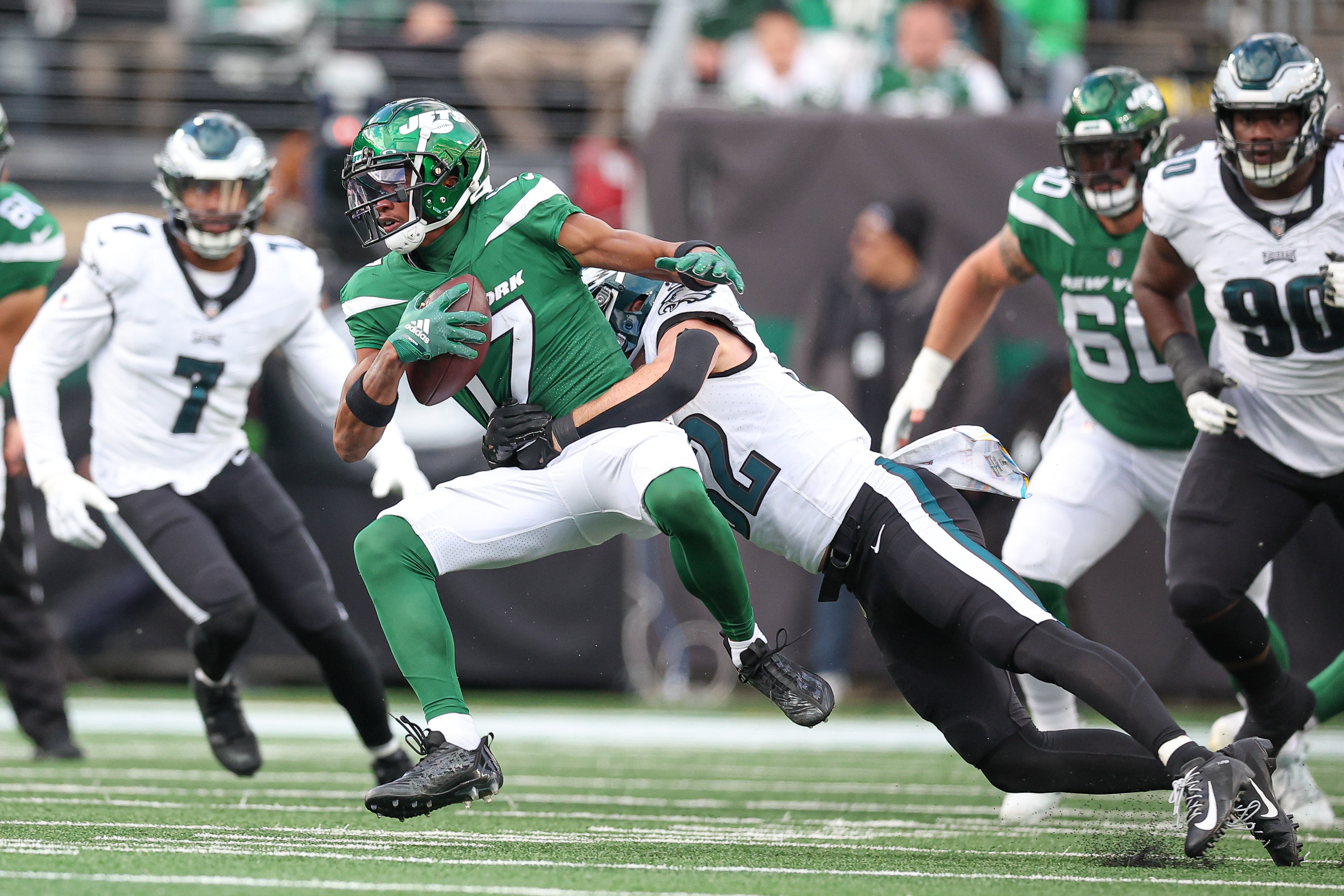 New York Jets wide receiver Garrett Wilson (17) is tackled by Philadelphia Eagles safety Reed Blankenship (32) during the first half at MetLife Stadium.