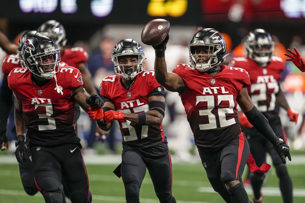 Ex-Falcons safety Jaylinn Hawkins celebrates an interception.