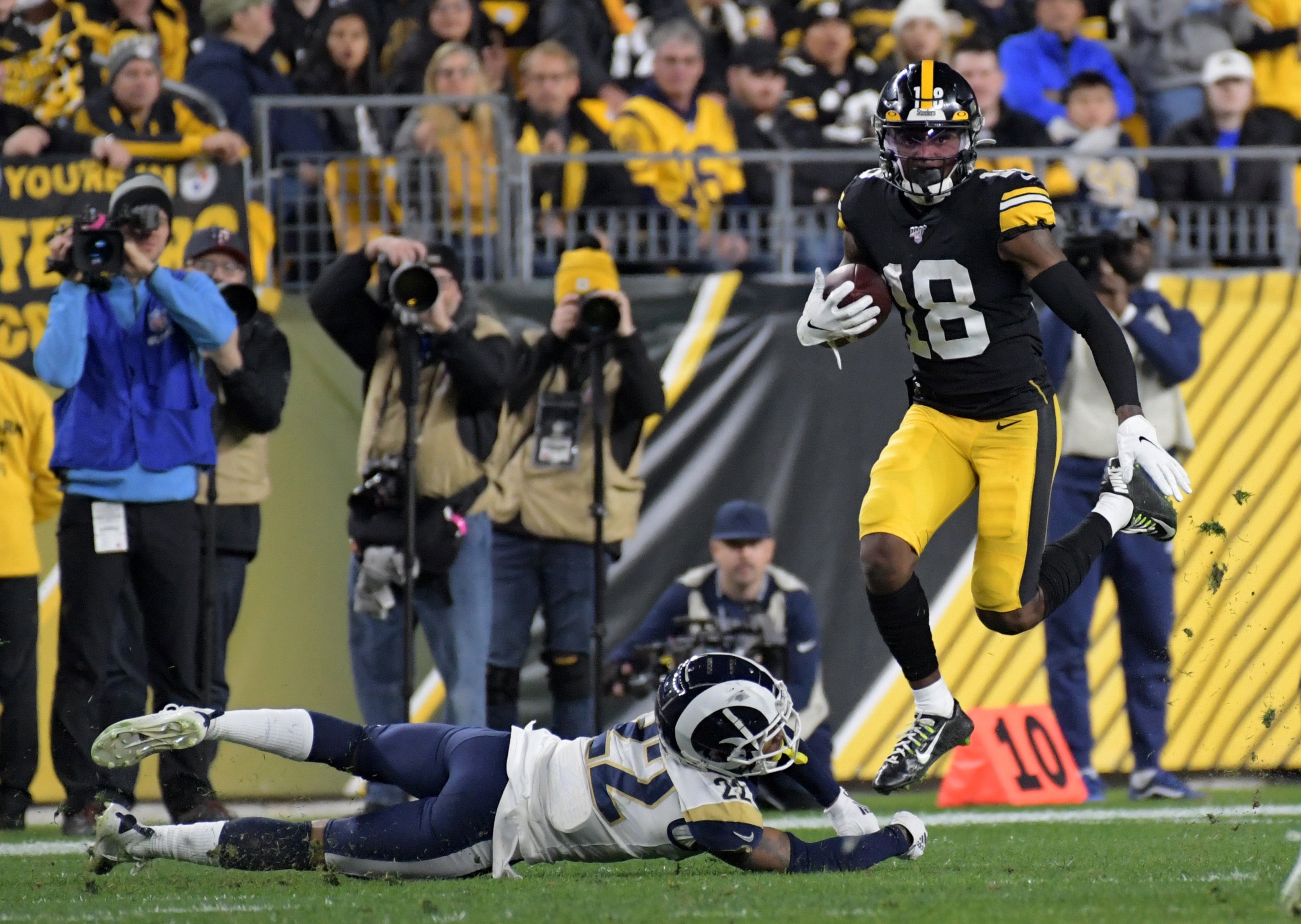 Nov 10, 2019; Pittsburgh, PA, USA; Pittsburgh Steelers wide receiver Diontae Johnson (18) leaps over Los Angeles Rams cornerback Troy Hill (22) at Heinz Field. Mandatory Credit: Kirby Lee-USA TODAY Sports