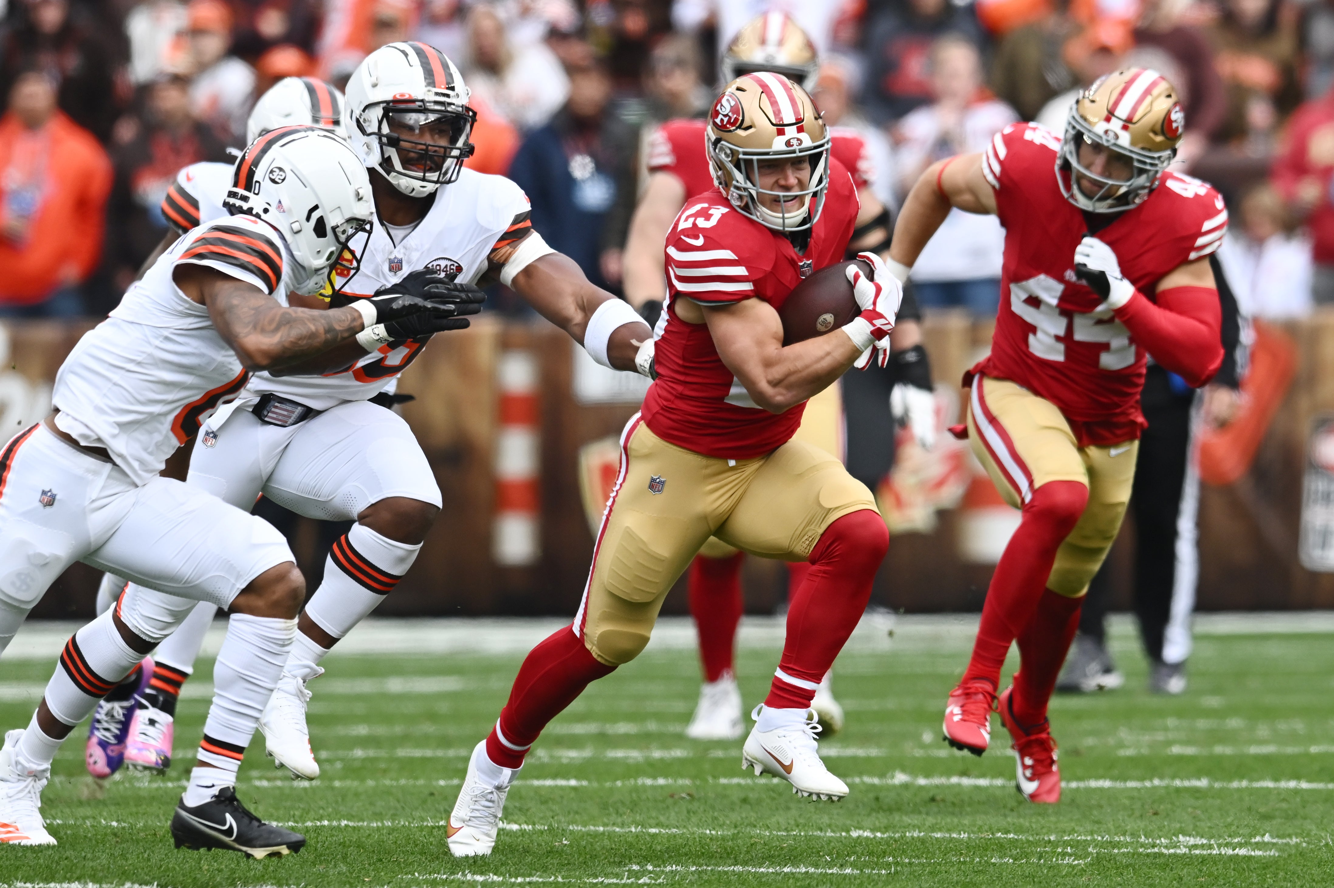 Oct 15, 2023; Cleveland, Ohio, USA; San Francisco 49ers running back Christian McCaffrey (23) runs with the ball against the Cleveland Browns during the first half at Cleveland Browns Stadium.