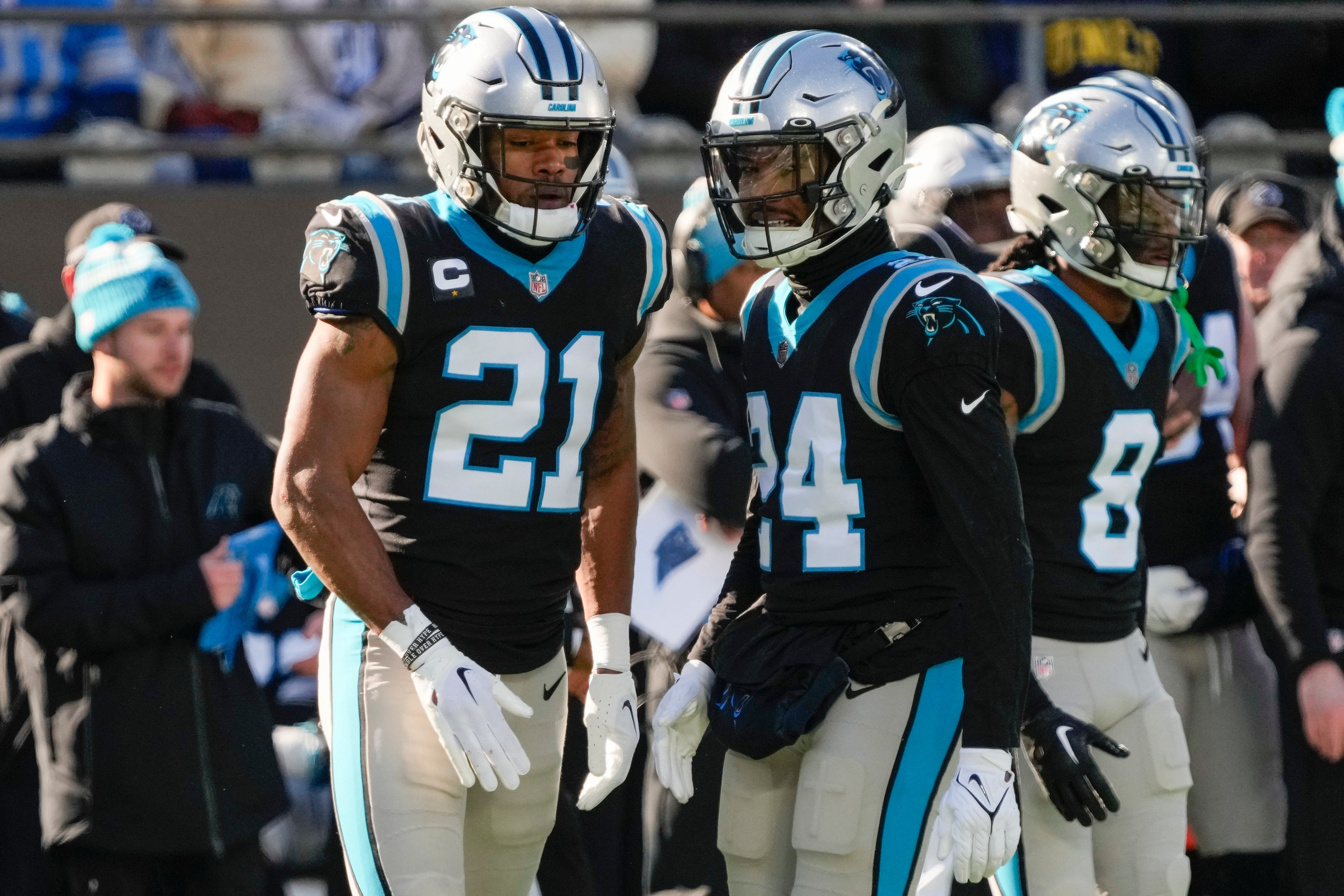Dec 24, 2022; Charlotte, North Carolina, USA; Carolina Panthers safety Jeremy Chinn (21) and cornerback CJ Henderson (24) converse during the second quarter against the Detroit Lions at Bank of America Stadium. Mandatory Credit: Jim Dedmon-USA TODAY Sports