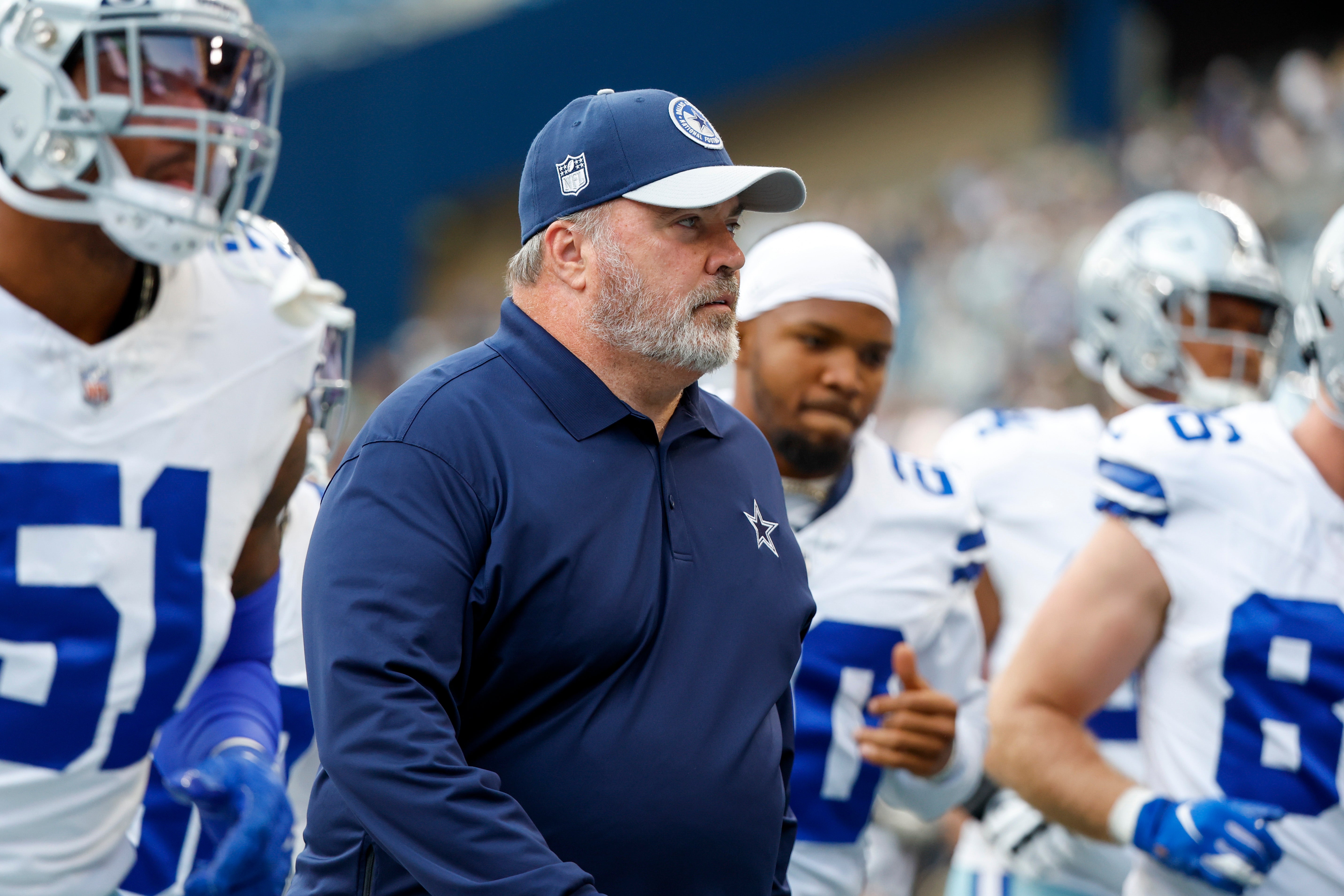 Dallas Cowboys head coach Mike McCarthy walks with his team back to the locker room following pregame warmups against the Seattle Seahawks at Lumen Field. Mandatory Credit: Joe Nicholson-USA TODAY Sports