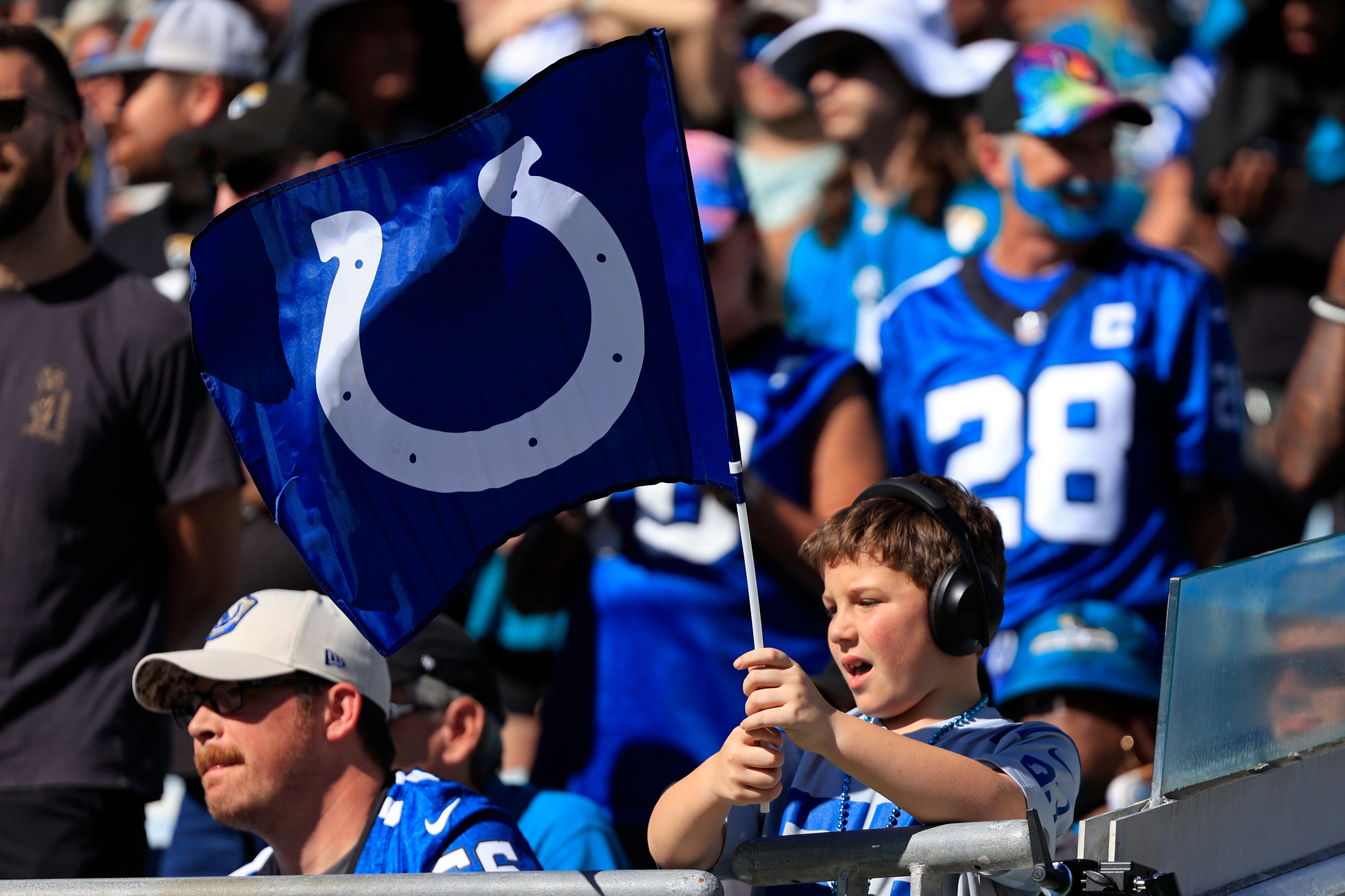 A Indianapolis Colts fan waves a flag during the fourth quarter of an NFL football matchup Sunday, Oct. 15, 2023 at EverBank Stadium in Jacksonville, Fla. The Jacksonville Jaguars defeated the Indianapolis Colts 37-20.