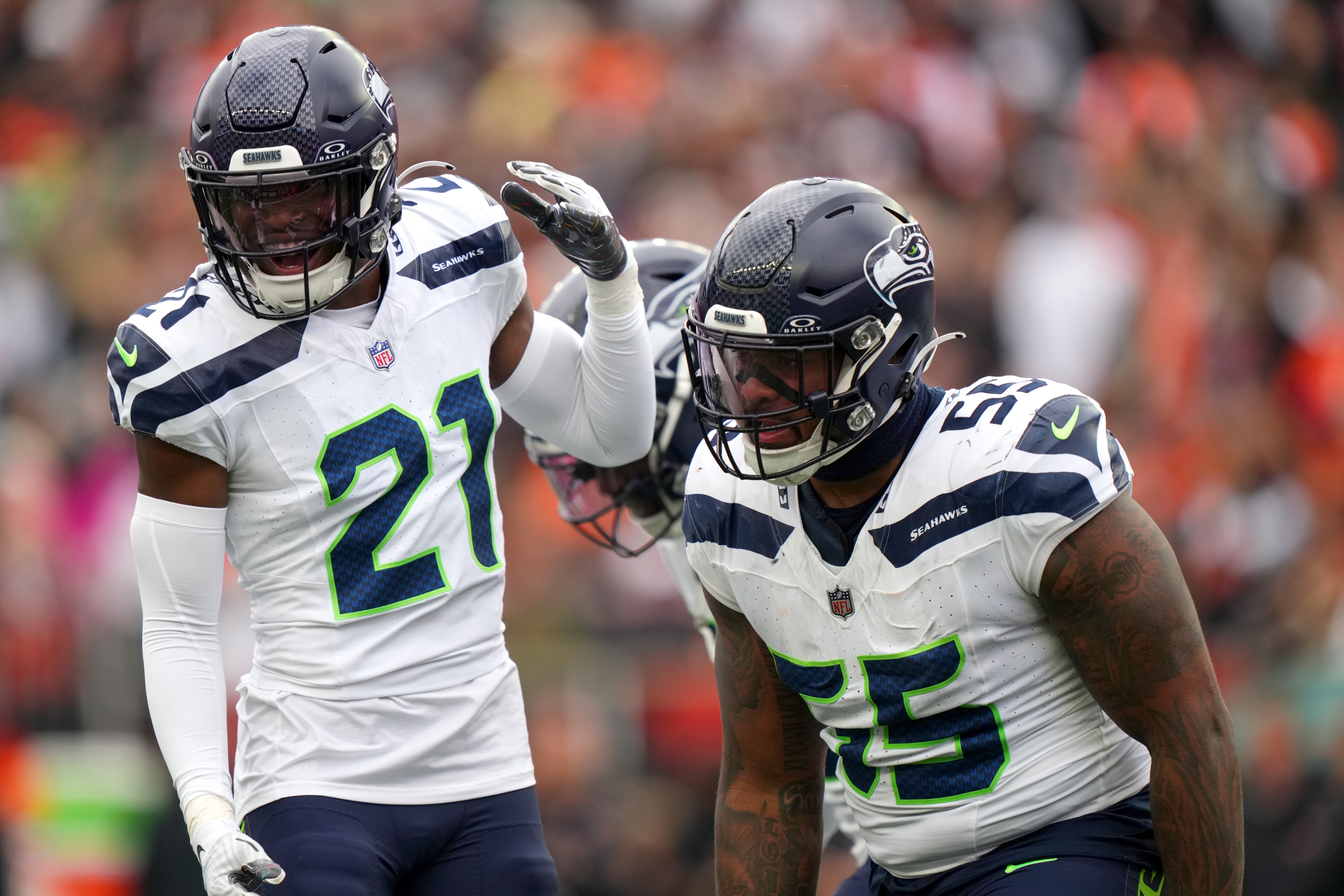 Oct 15, 2023; Cincinnati, Ohio, USA; Seattle Seahawks defensive end Dre'Mont Jones (55) is congratulated by Seattle Seahawks cornerback Devon Witherspoon (21) after a sack in the third quarter at Paycor Stadium. Mandatory Credit: Kareem Elgazzar-USA TODAY Sports