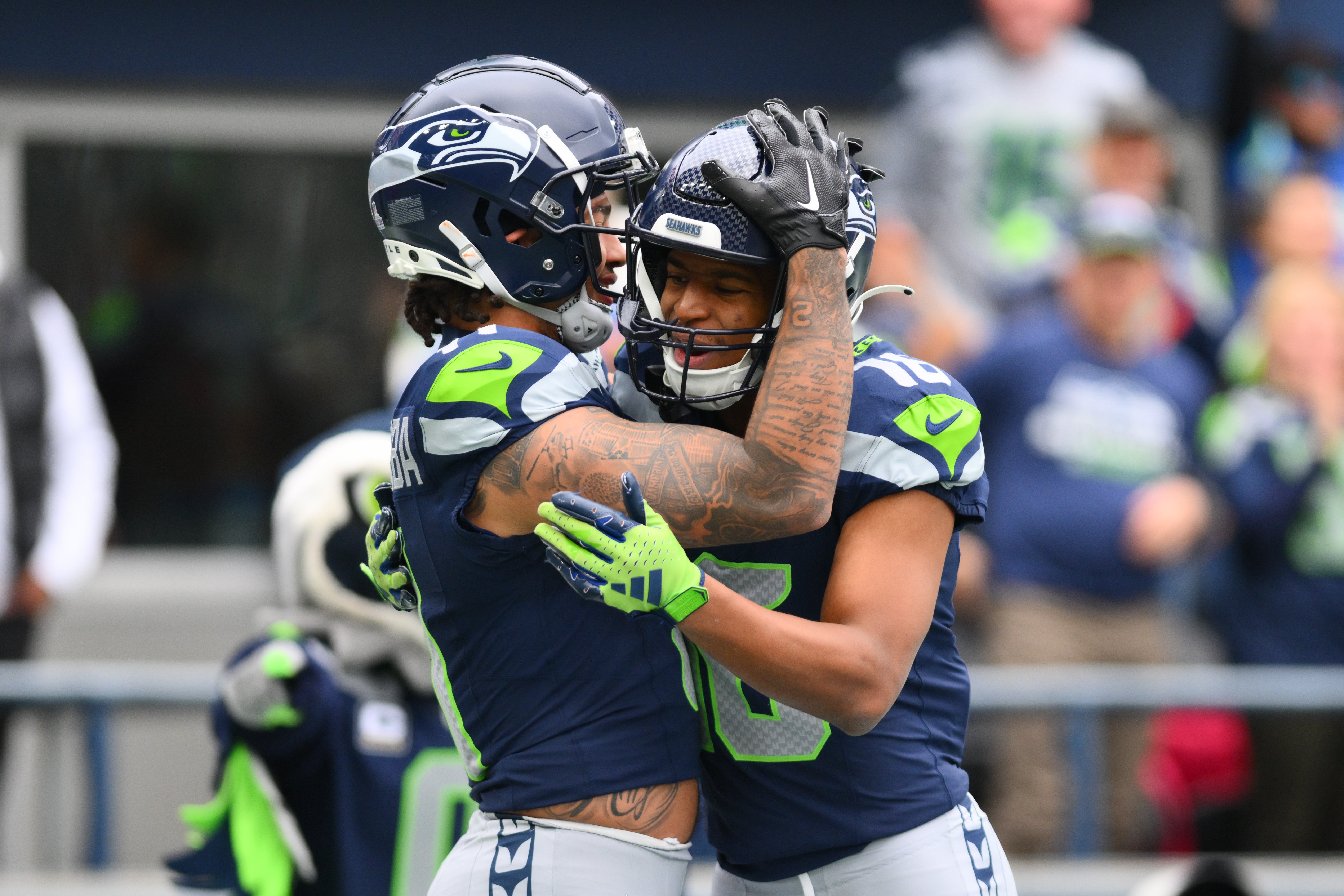 Oct 22, 2023; Seattle, Washington, USA; Seattle Seahawks wide receiver Jaxon Smith-Njigba (11) and Seattle Seahawks wide receiver Tyler Lockett (16) celebrate after Jaxon Smith-Njigba scored a touchdown against the Arizona Cardinals during the first half at Lumen Field. Mandatory Credit: Steven Bisig-USA TODAY Sports