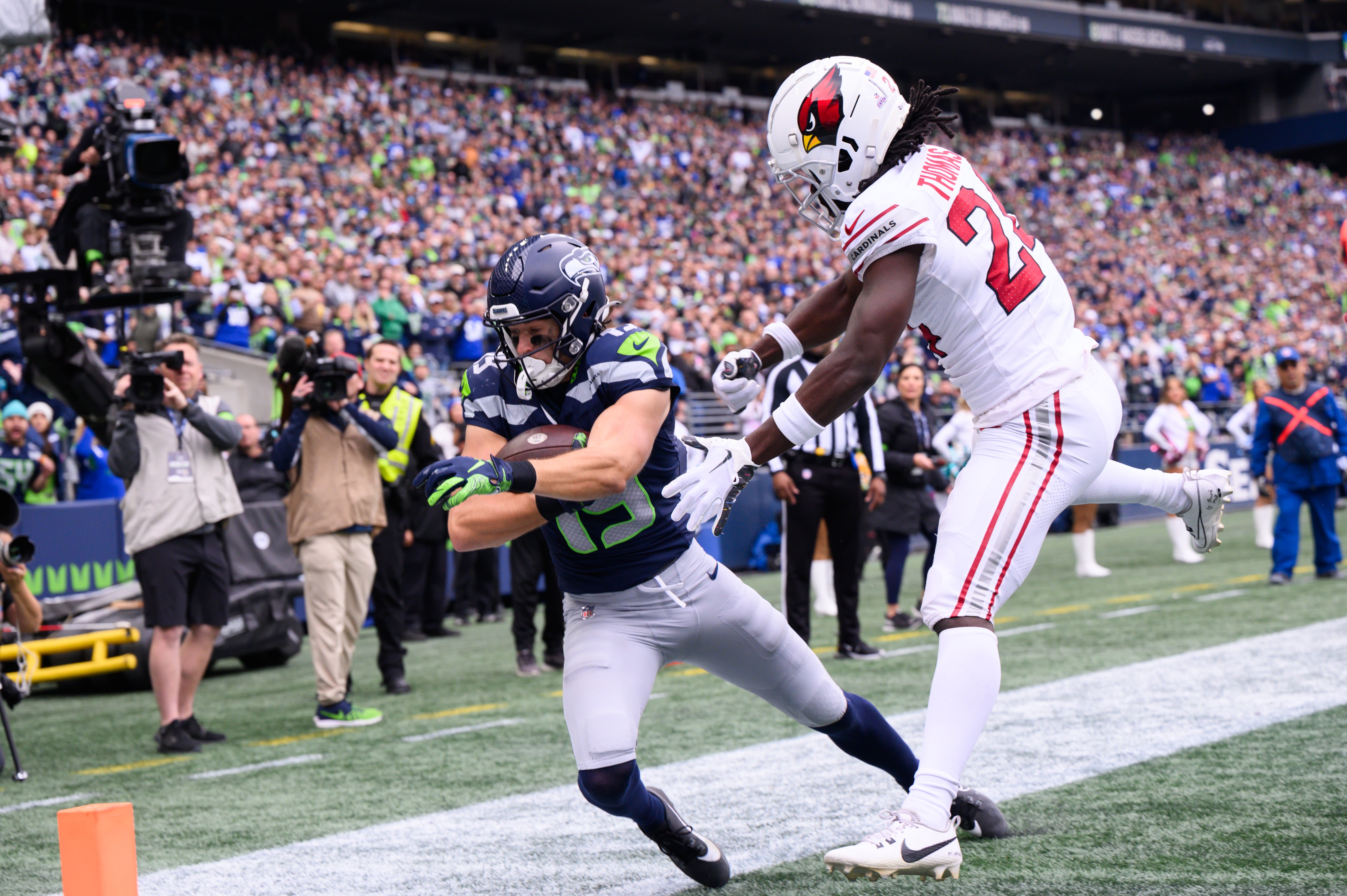 Oct 22, 2023; Seattle, Washington, USA; Seattle Seahawks wide receiver Jake Bobo (19) catches a pass for a touchdown over Arizona Cardinals cornerback Starling Thomas V (24) during the first half at Lumen Field. Mandatory Credit: Steven Bisig-USA TODAY Sports