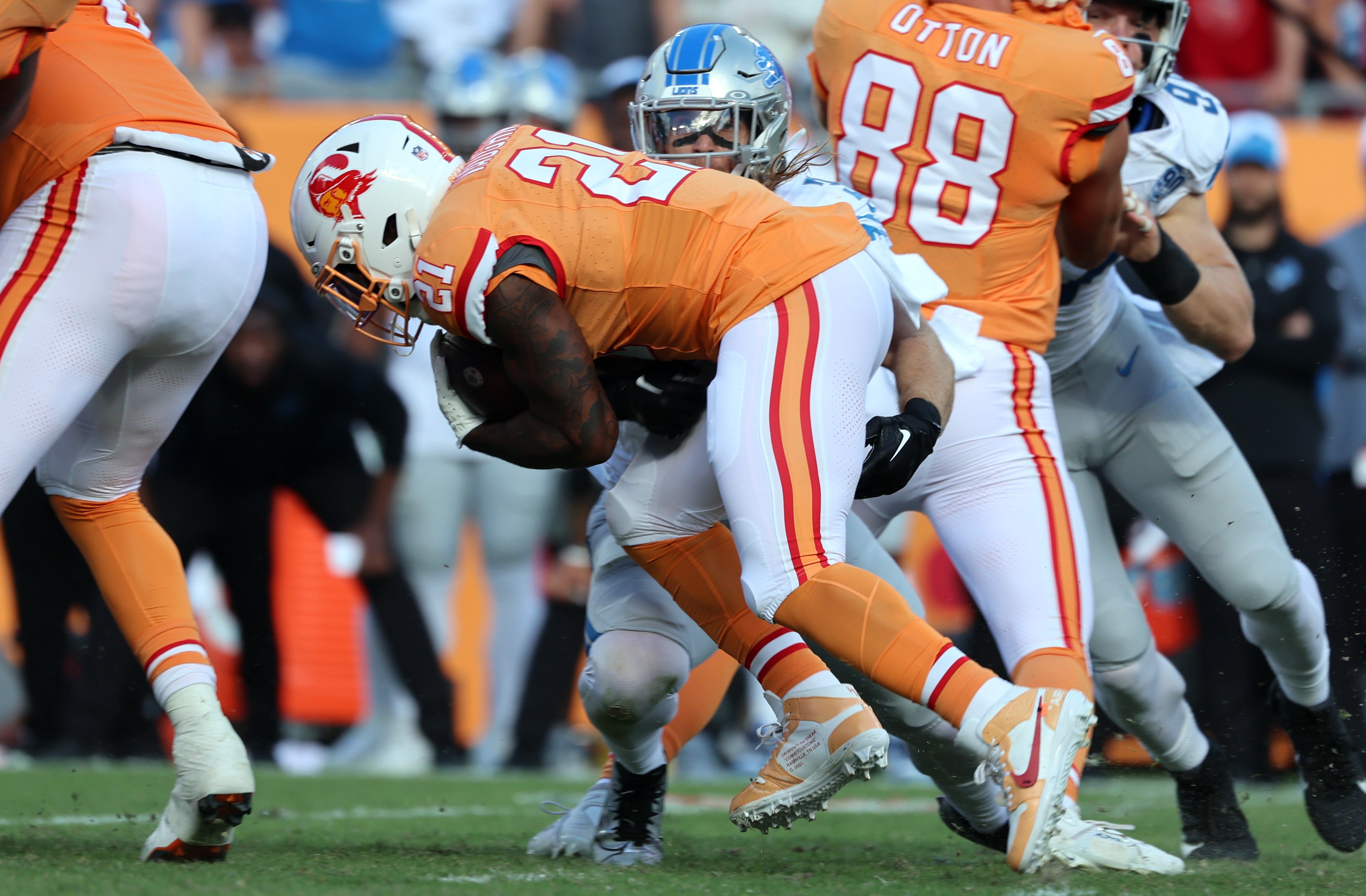 Oct 15, 2023; Tampa, Florida, USA; Detroit Lions linebacker Alex Anzalone (34) tackles Tampa Bay Buccaneers running back Ke'Shawn Vaughn (21) during the first half at Raymond James Stadium. Mandatory Credit: Kim Klement Neitzel-USA TODAY Sports