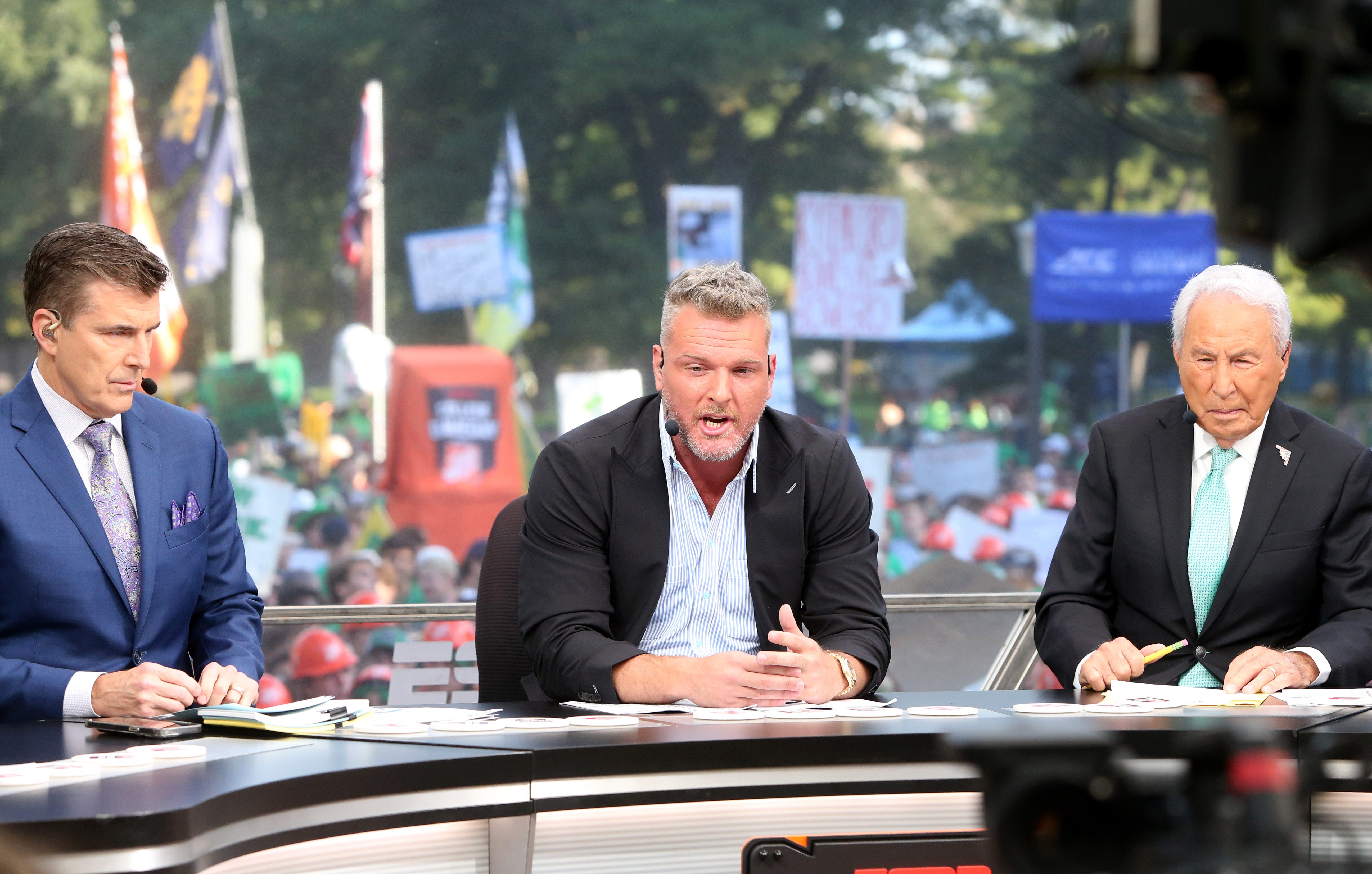 Host Pat McAfee, center, makes a point while Rece Davis, left, and Lee Corso look on during the ESPN College GameDay show on Saturday, Sept. 23, 2023, on the Hesburgh Library lawn on the University of Notre Dame campus in South Bend. The show was to highlight the Notre Dame-Ohio State game.