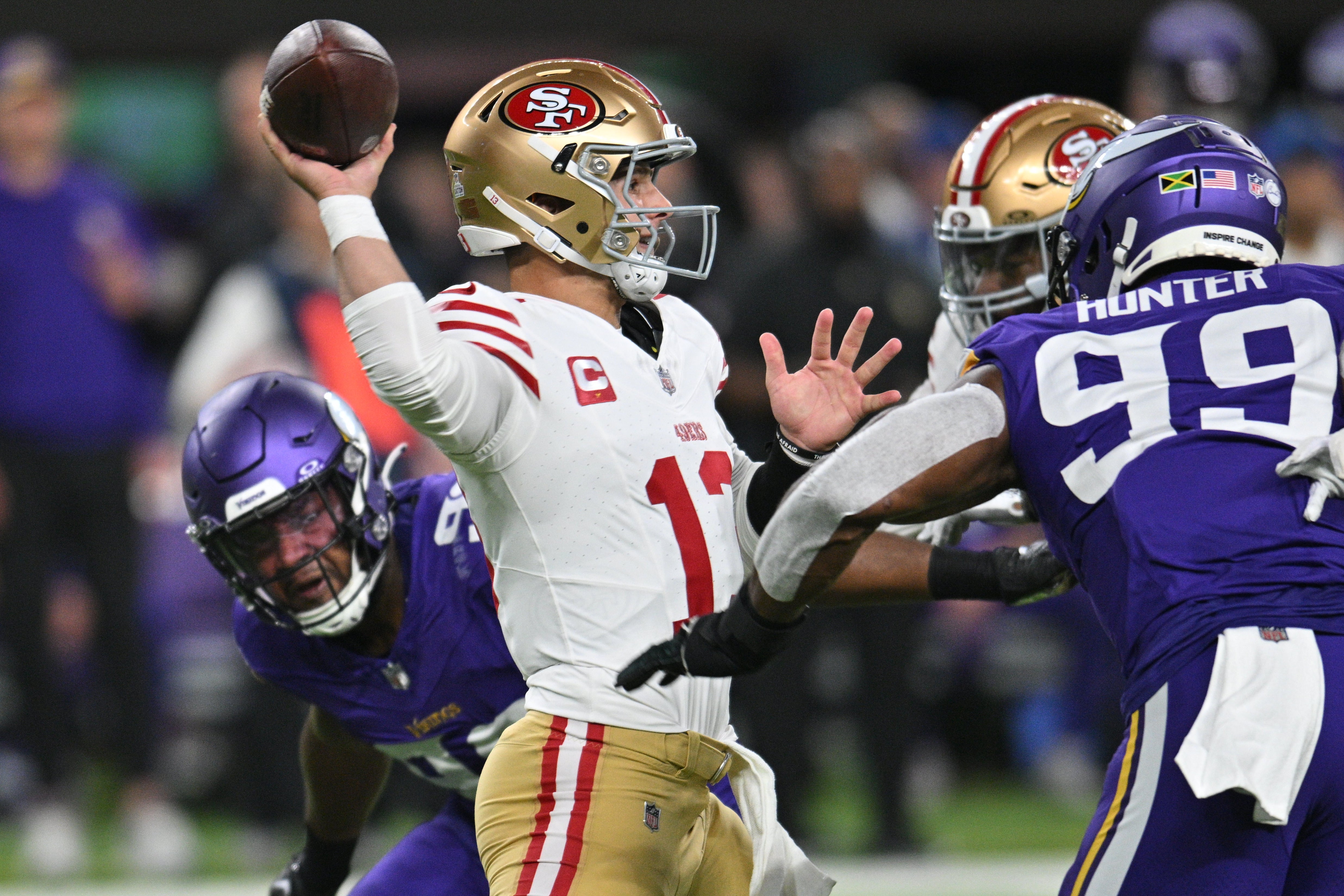 Oct 23, 2023; Minneapolis, Minnesota, USA; San Francisco 49ers quarterback Brock Purdy (13) throws a pass as Minnesota Vikings linebacker Danielle Hunter (99) and linebacker D.J. Wonnum (left) rush in during the first quarter at U.S. Bank Stadium.