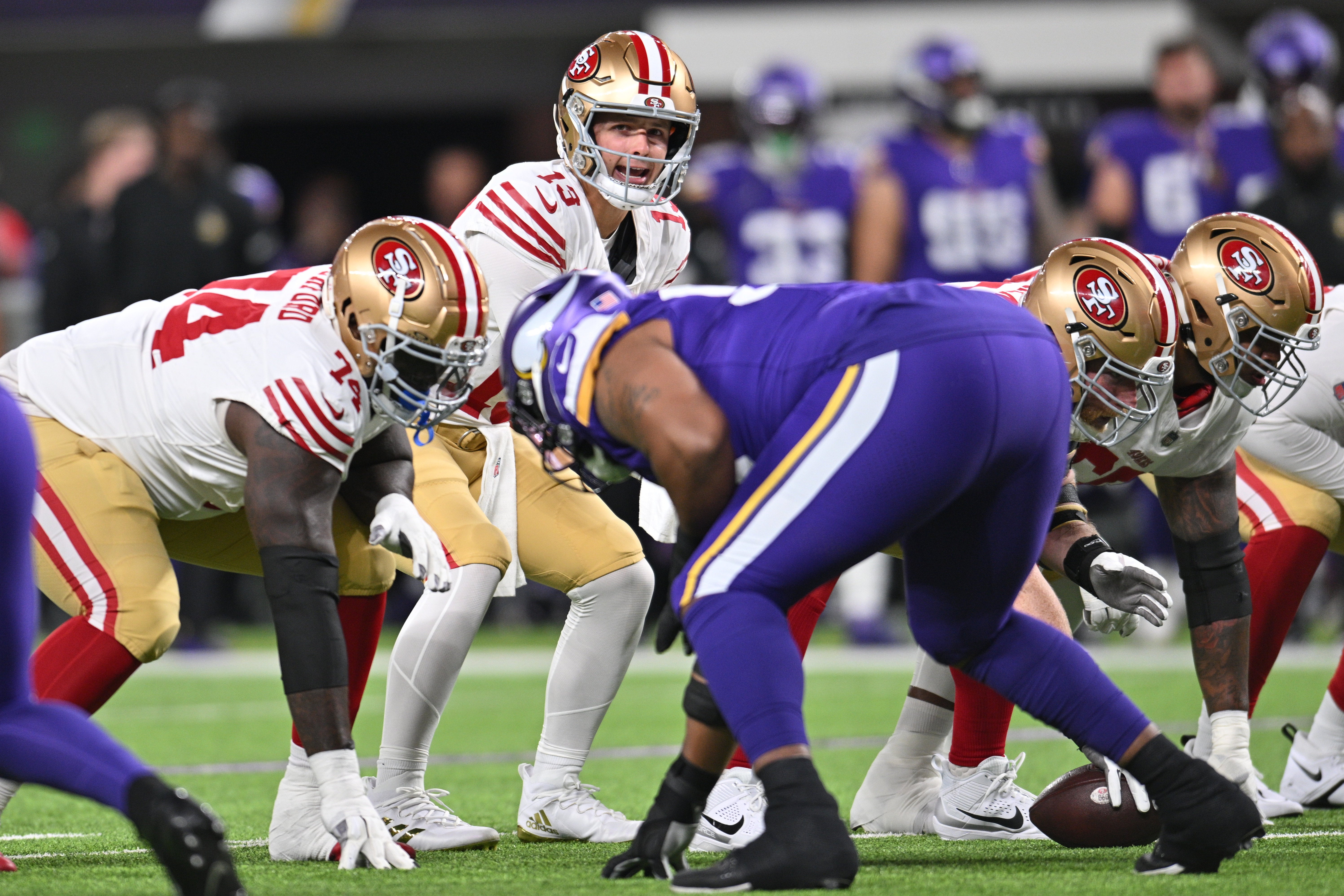 Oct 23, 2023; Minneapolis, Minnesota, USA; San Francisco 49ers quarterback Brock Purdy (13) controls the offense as offensive tackle Spencer Burford (74) prepares to block against the Minnesota Vikings during the first quarter at U.S. Bank Stadium.