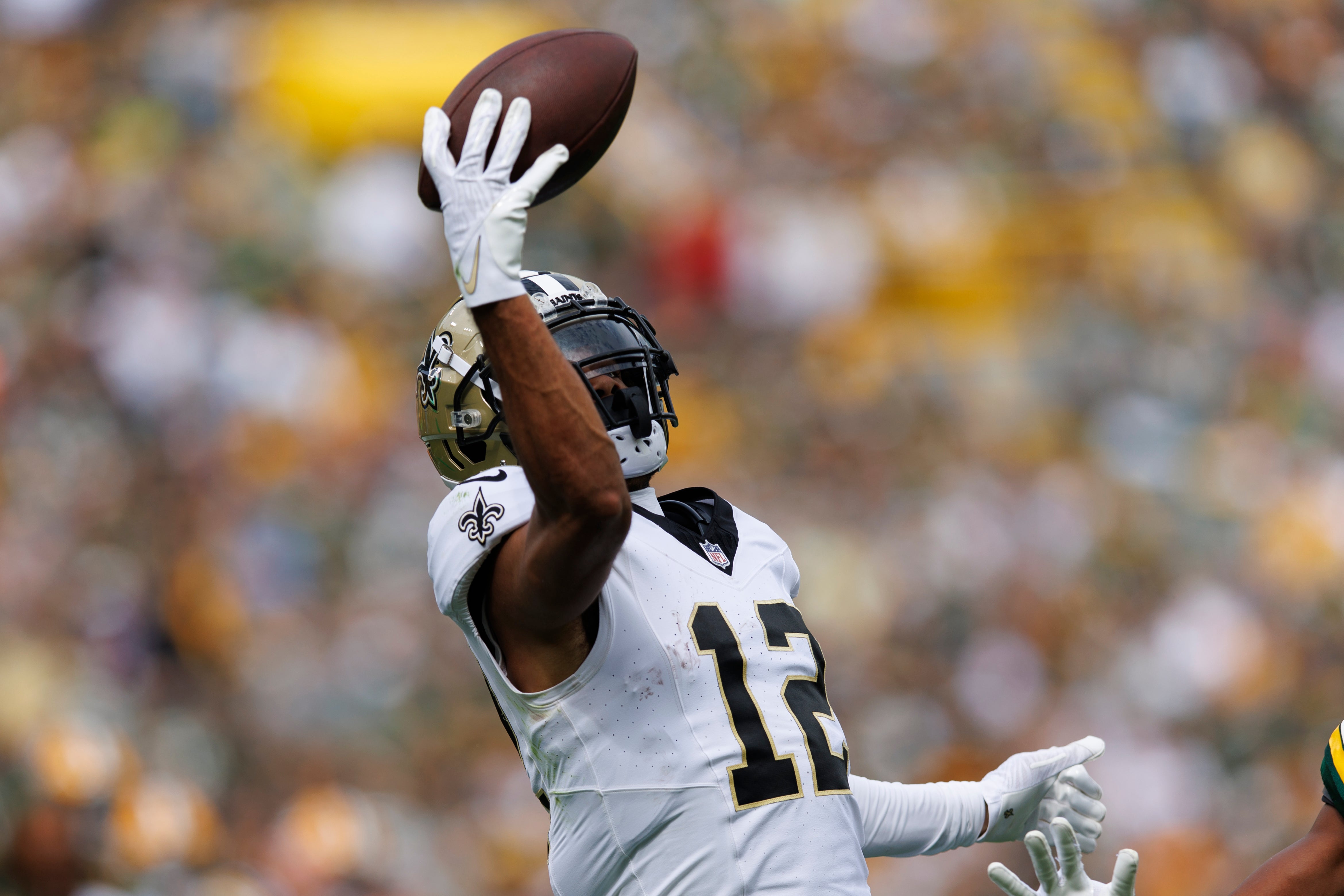 Sep 24, 2023; Green Bay, Wisconsin, USA; New Orleans Saints wide receiver Chris Olave (12) reaches to catch a pass during the second quarter against the Green Bay Packers at Lambeau Field.