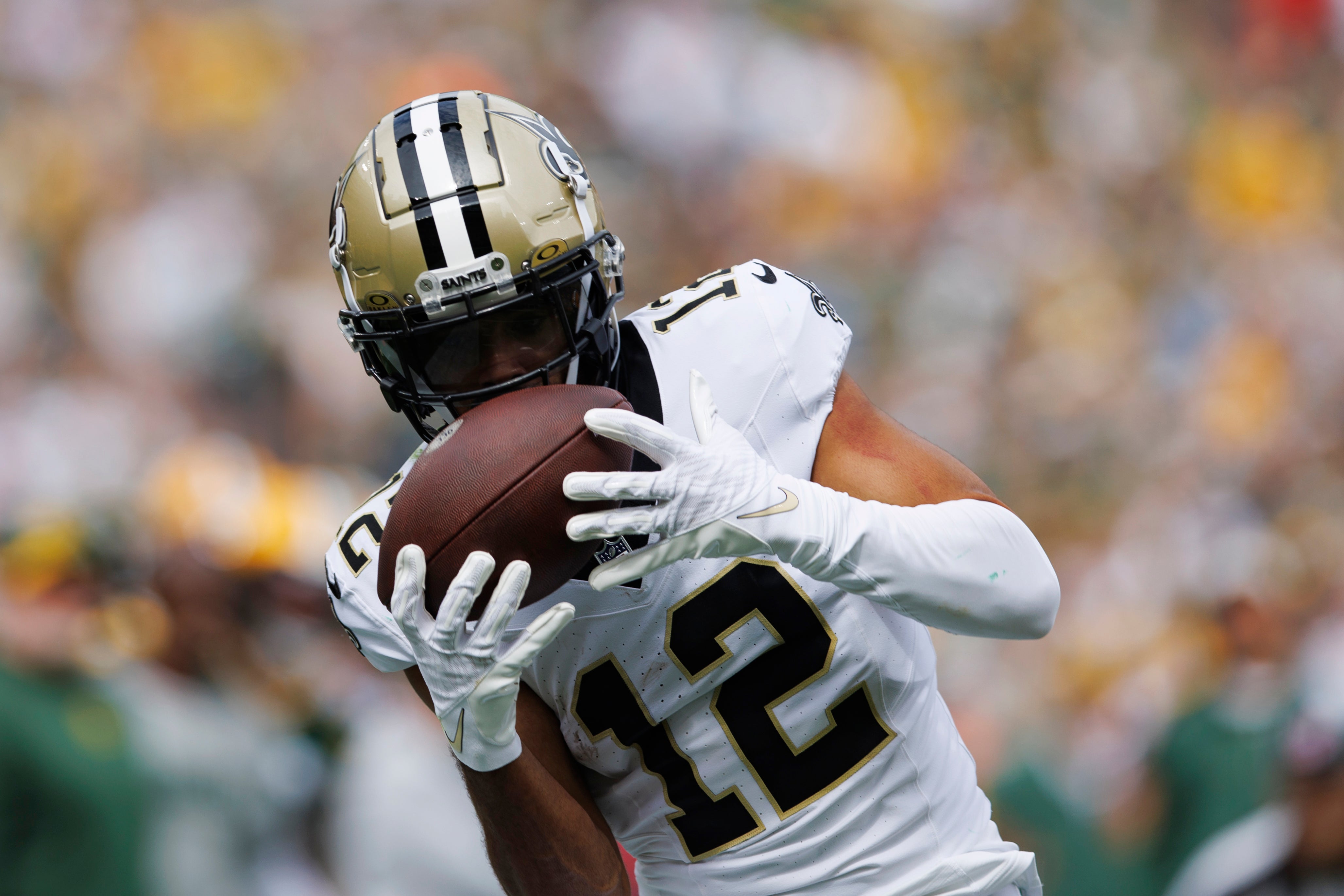 Sep 24, 2023; Green Bay, Wisconsin, USA; New Orleans Saints wide receiver Chris Olave (12) catches a pass during the second quarter against the Green Bay Packers at Lambeau Field.