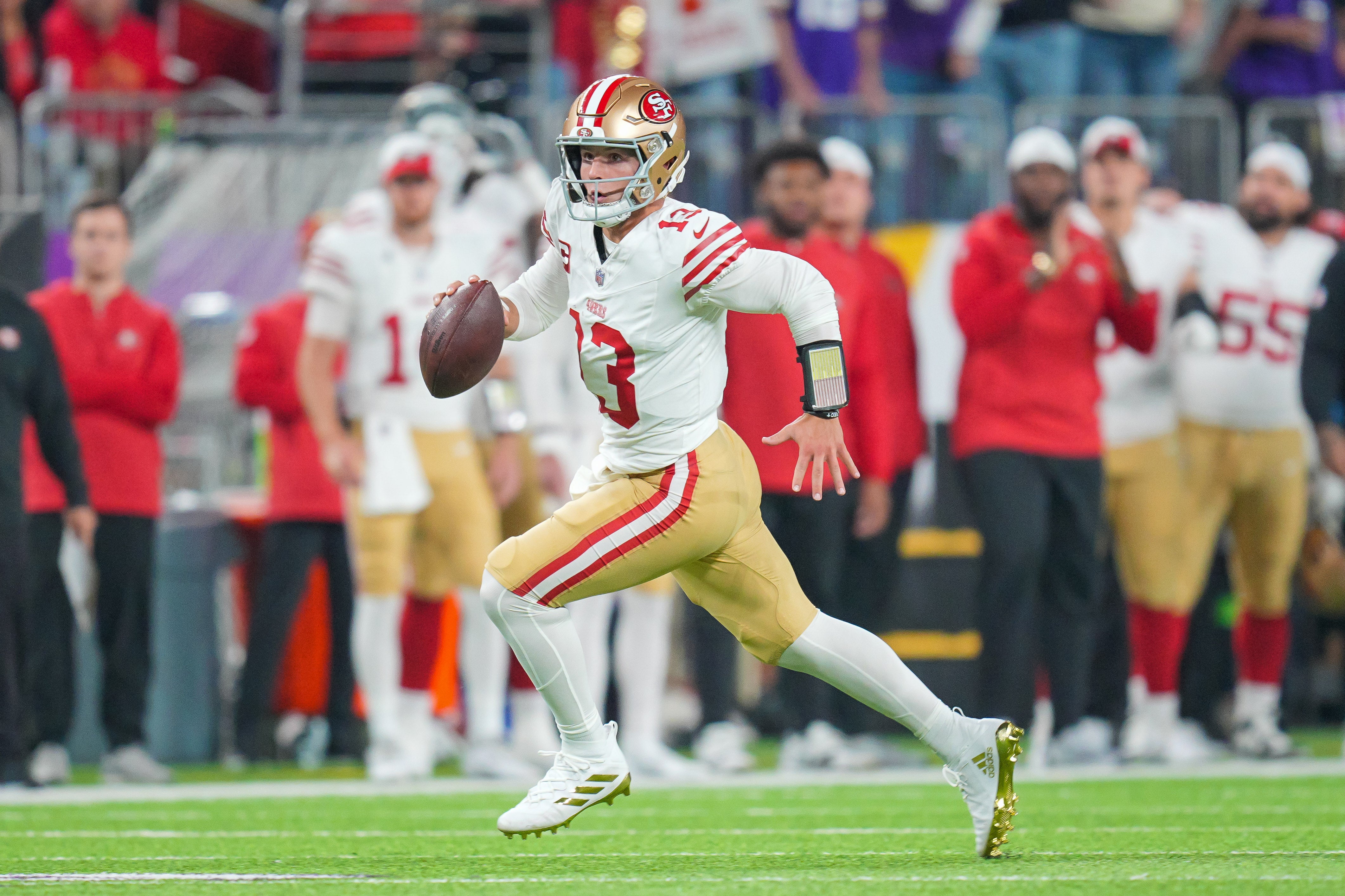 Oct 23, 2023; Minneapolis, Minnesota, USA; San Francisco 49ers quarterback Brock Purdy (13) scrambles against the Minnesota Vikings in the first quarter at U.S. Bank Stadium.